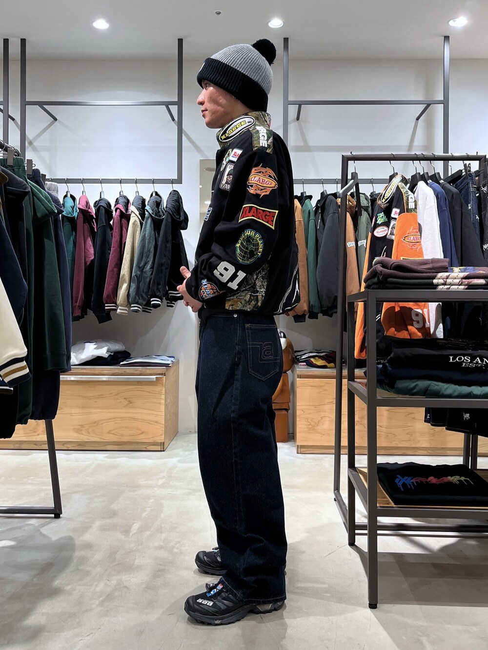 ブラック系のブルゾン、ブルー系のデニムパンツ、グレー系のニットキャップ/ビーニーを着用したメンズの秋コーディネートの3枚目の写真