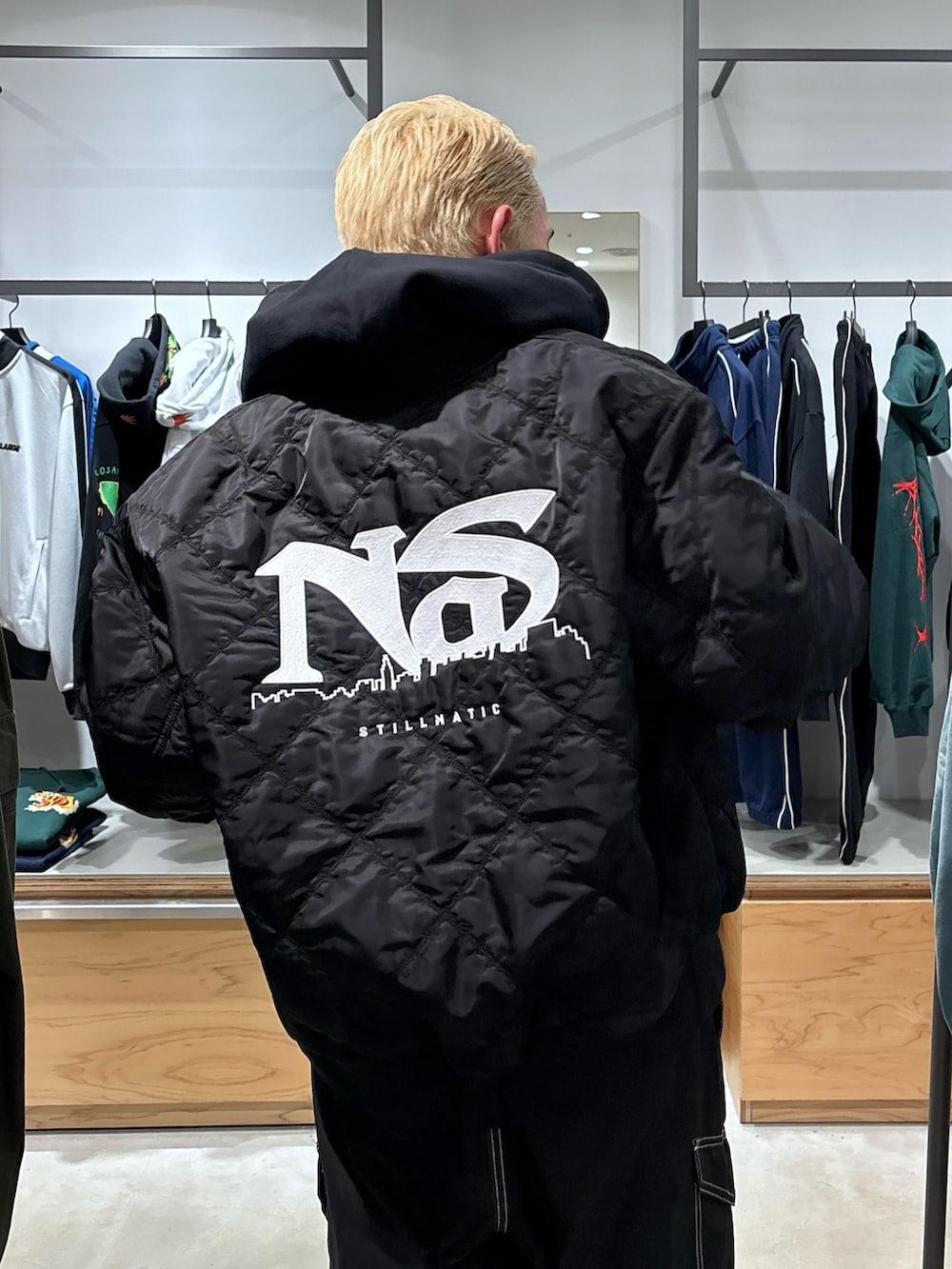 ブラック系のカーゴパンツ、ブラック系のブルゾン、ブラック系のパーカーを着用したメンズの冬コーディネートの7枚目の写真