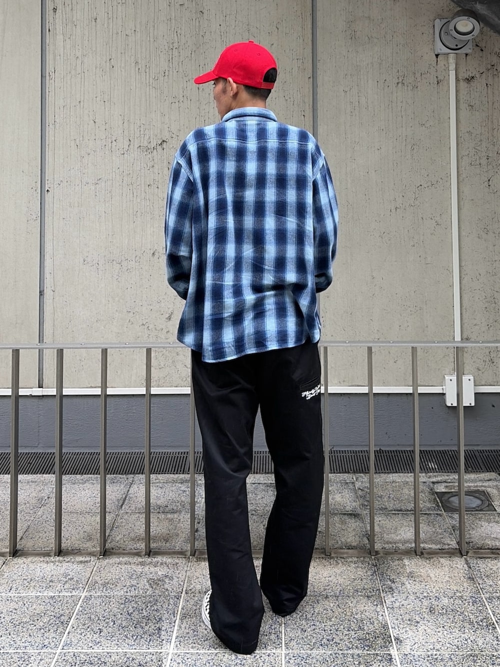 ブルー系のシャツ/ブラウス、ブラック系のその他パンツ、レッド系のキャップを着用したメンズの秋コーディネートの6枚目の写真