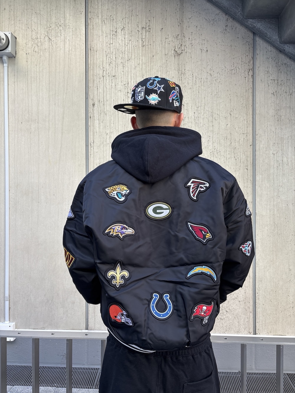 ブラック系のブルゾン、ブラック系のパーカー、ブラック系のスウェットパンツを着用したメンズの冬コーディネートの7枚目の写真