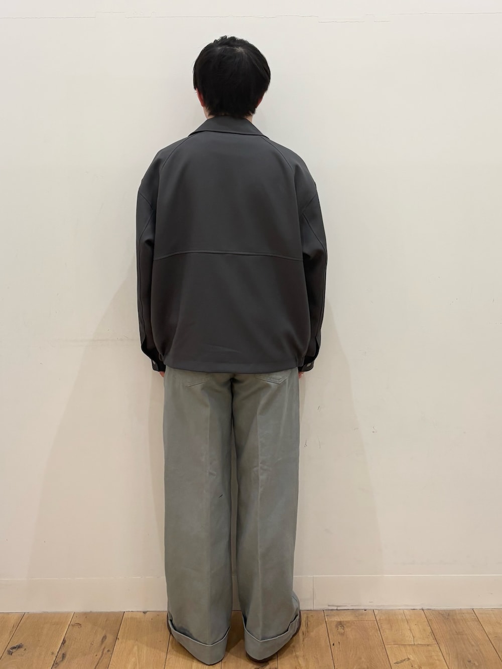 ブラック系のニット/セーター、ブルー系のブルゾン、ブルー系のその他パンツを着用したメンズの春コーディネートの3枚目の写真