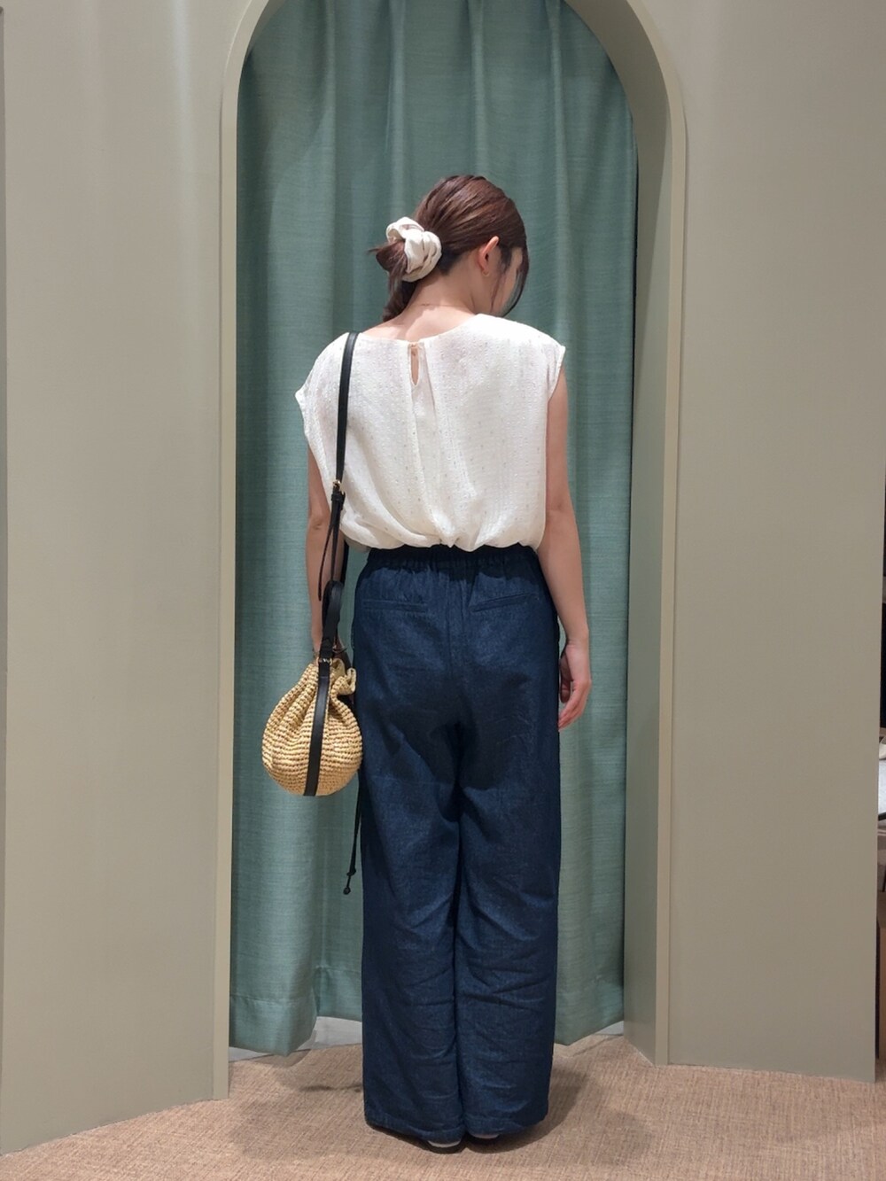 ホワイト系のシャツ/ブラウス、ブルー系のデニムパンツ、ベージュ系のトートバッグを着用したレディースの夏コーディネートの2枚目の写真