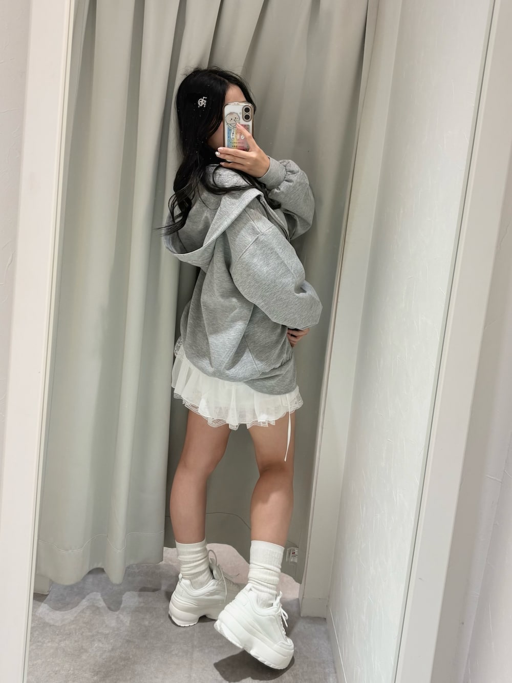 グレー系のパーカー、ホワイト系のスカート、グレー系のTシャツ/カットソーを着用したレディースの春コーディネートの4枚目の写真