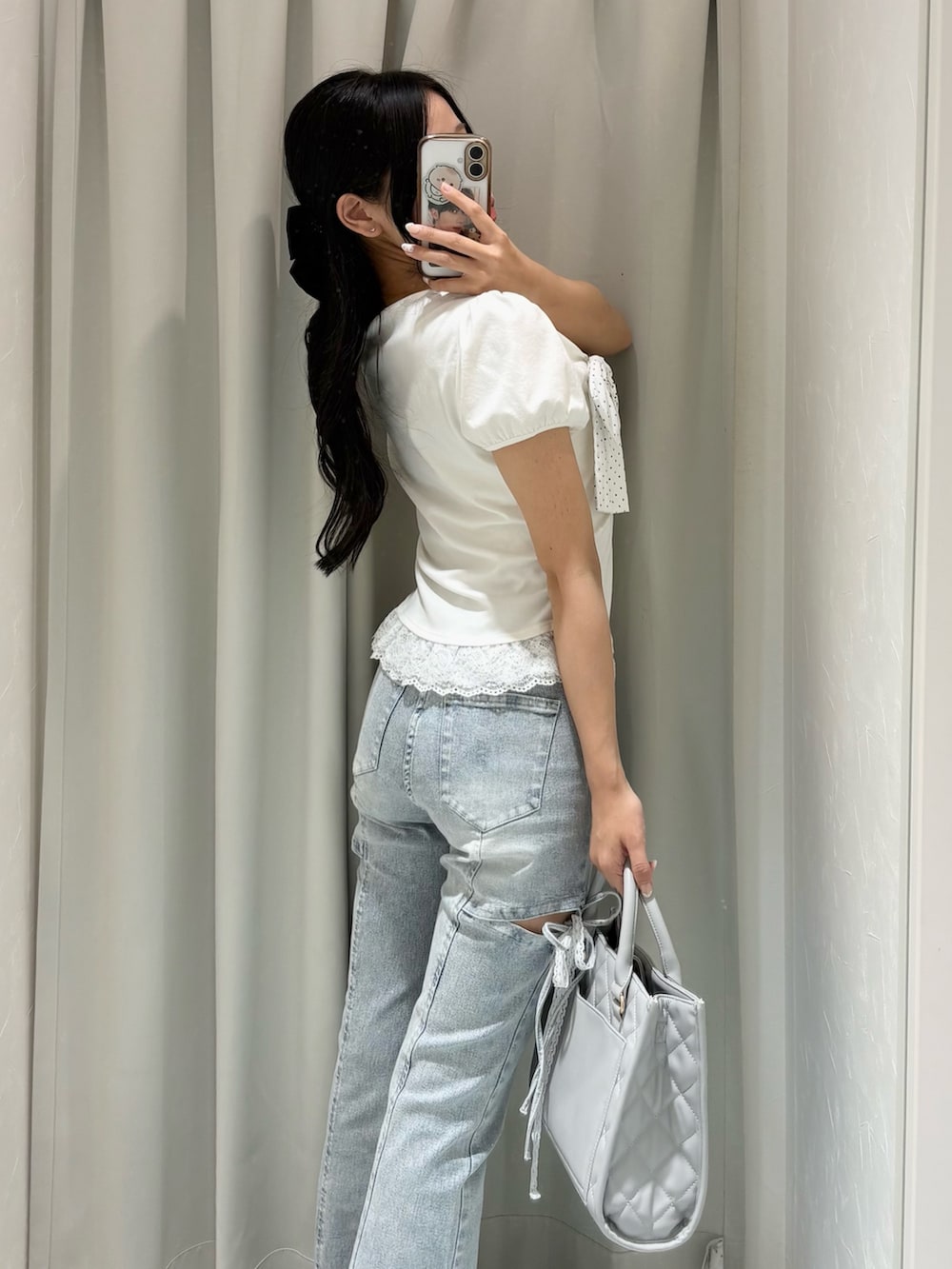 ホワイト系のTシャツ/カットソー、ブルー系のデニムパンツ、グレー系のショルダーバッグを着用したレディースの春コーディネートの4枚目の写真