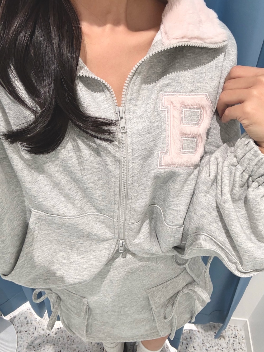 グレー系のTシャツ/カットソー、グレー系のスカート、ホワイト系のその他シューズを着用したレディースの秋コーディネートの4枚目の写真