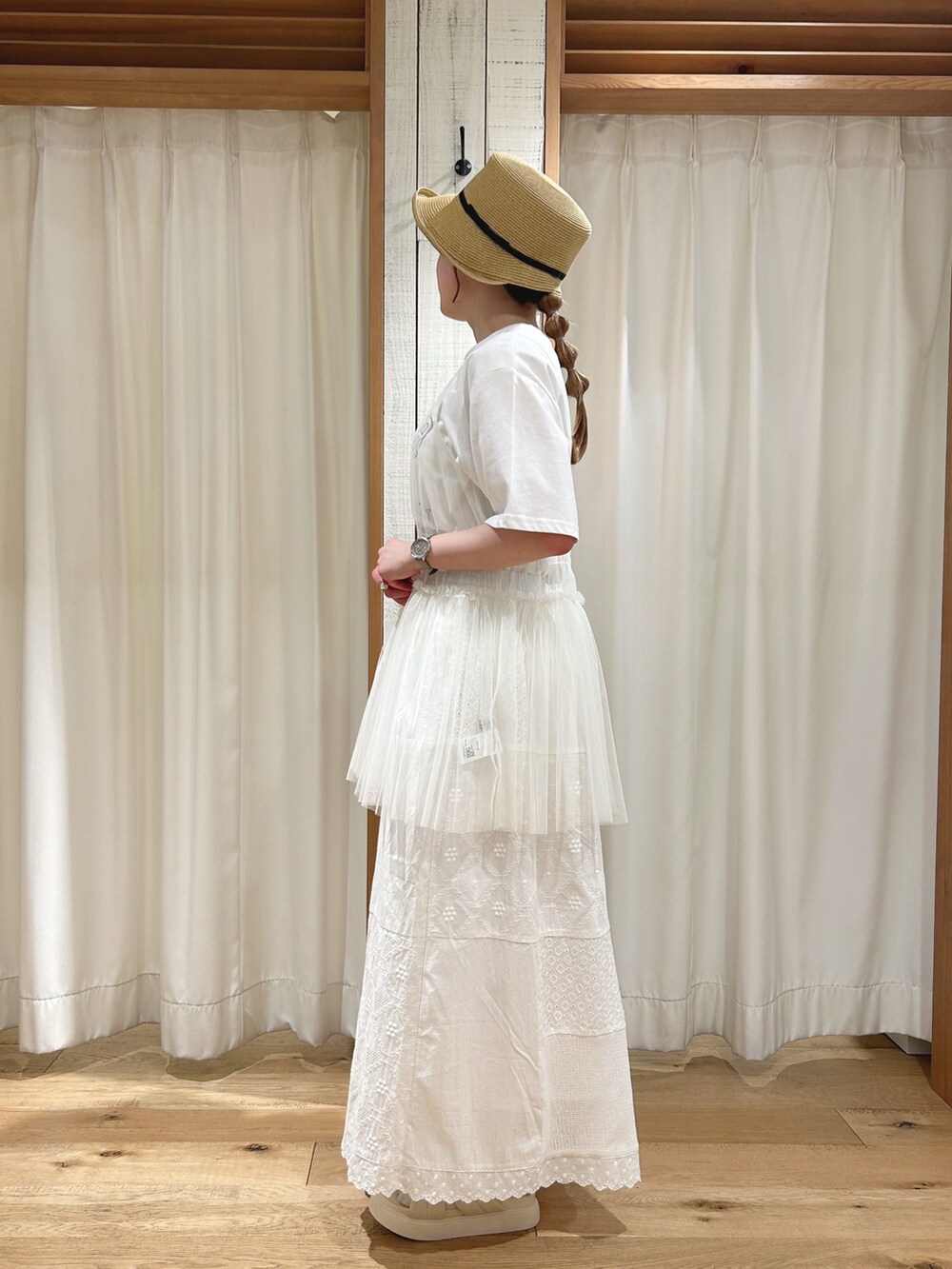 ホワイト系のTシャツ/カットソー、ホワイト系のスカート、ブラック系の帽子を着用したレディースの春コーディネートの2枚目の写真