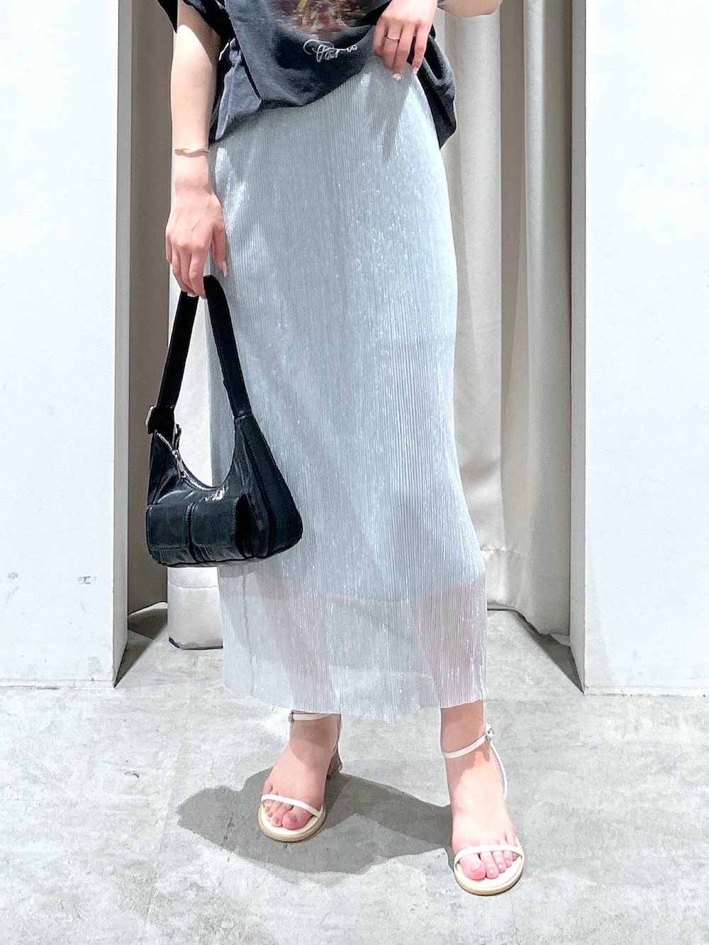 ブラック系のTシャツ/カットソー、シルバー系のスカート、ブラック系のショルダーバッグを着用したレディースの夏コーディネートの6枚目の写真