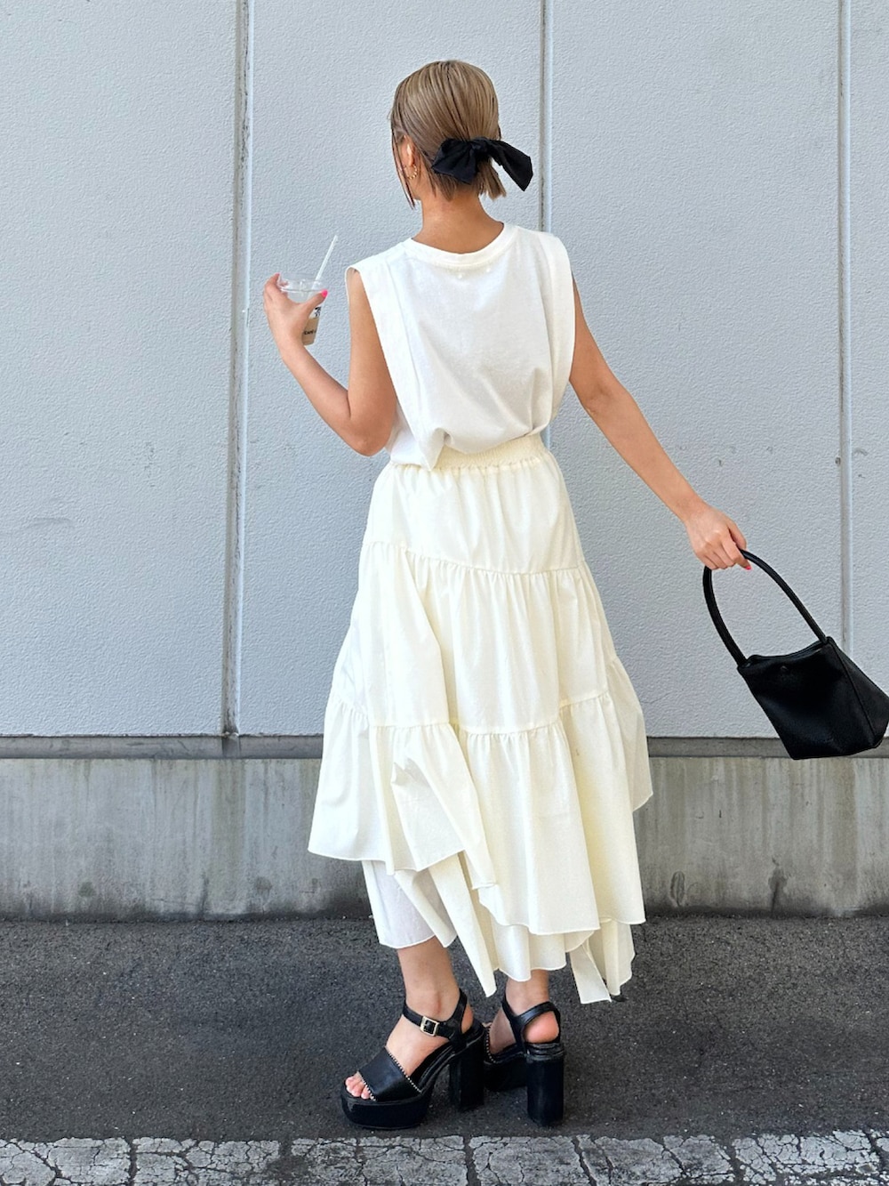 ホワイト系のスカートを着用したレディースの春コーディネートの2枚目の写真
