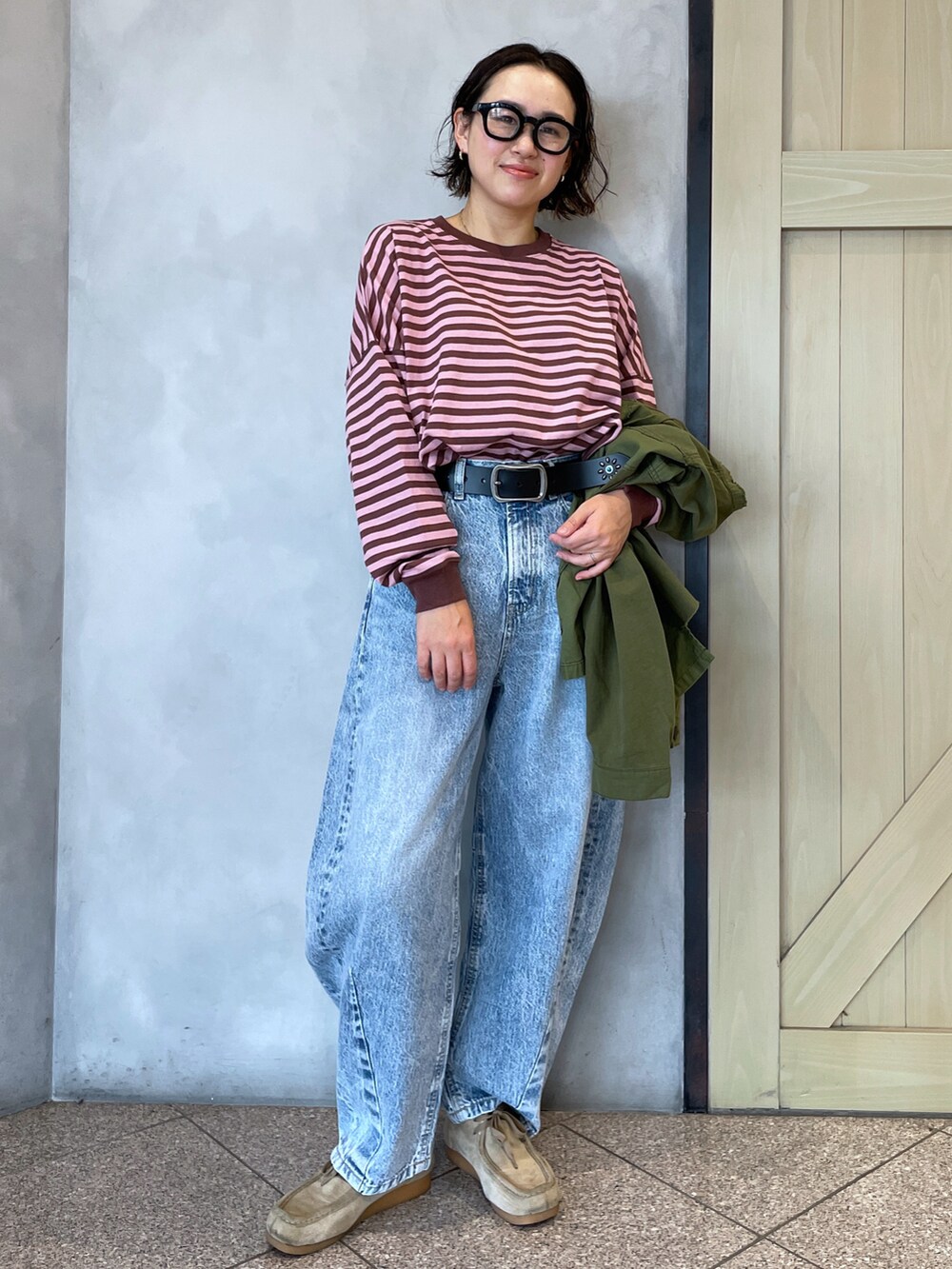 ピンク系のワンピース、ブルー系のデニムパンツを着用したレディースの秋コーディネートの2枚目の写真