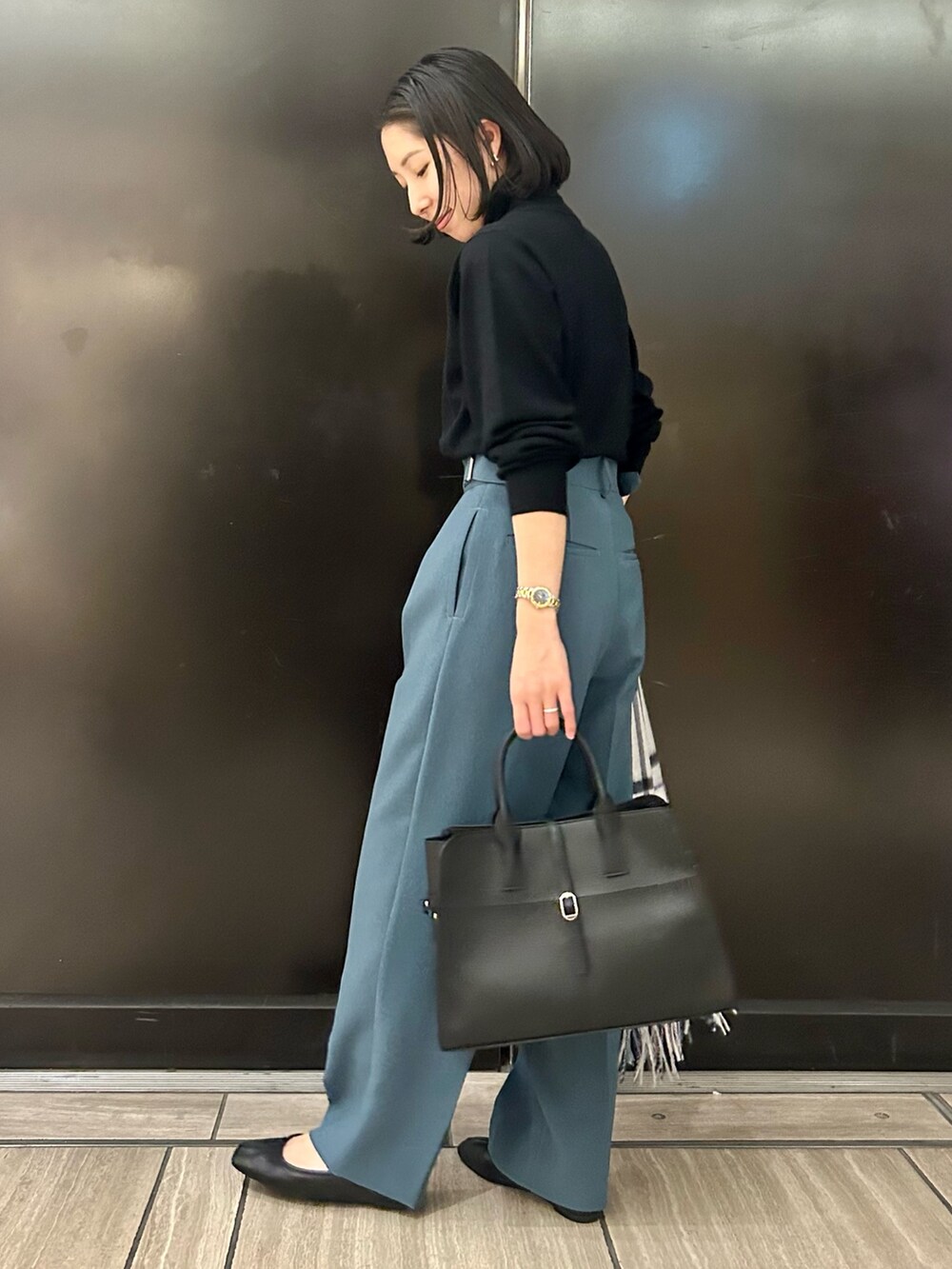 ブラック系のニット/セーター、ブルー系のその他パンツ、ブラック系のトートバッグを着用したレディースの秋コーディネートの2枚目の写真