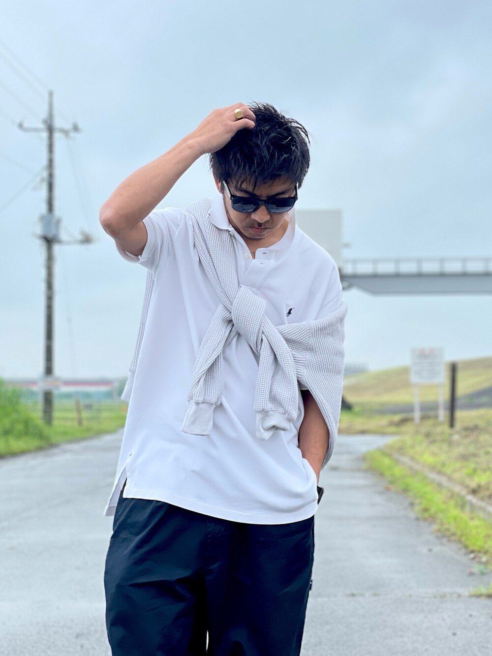 グレー系のスウェット、ホワイト系のポロシャツ、ブルー系のチノパンツを着用したメンズの春コーディネートの4枚目の写真