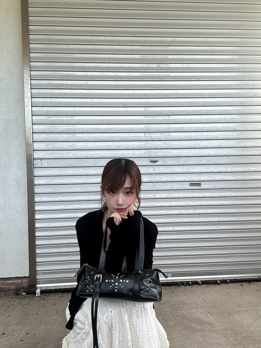 ブラック系のショルダーバッグ、ピンク系のサンダル、ブラック系のカーディガン/ボレロを着用したレディースの秋コーディネートの3枚目の写真