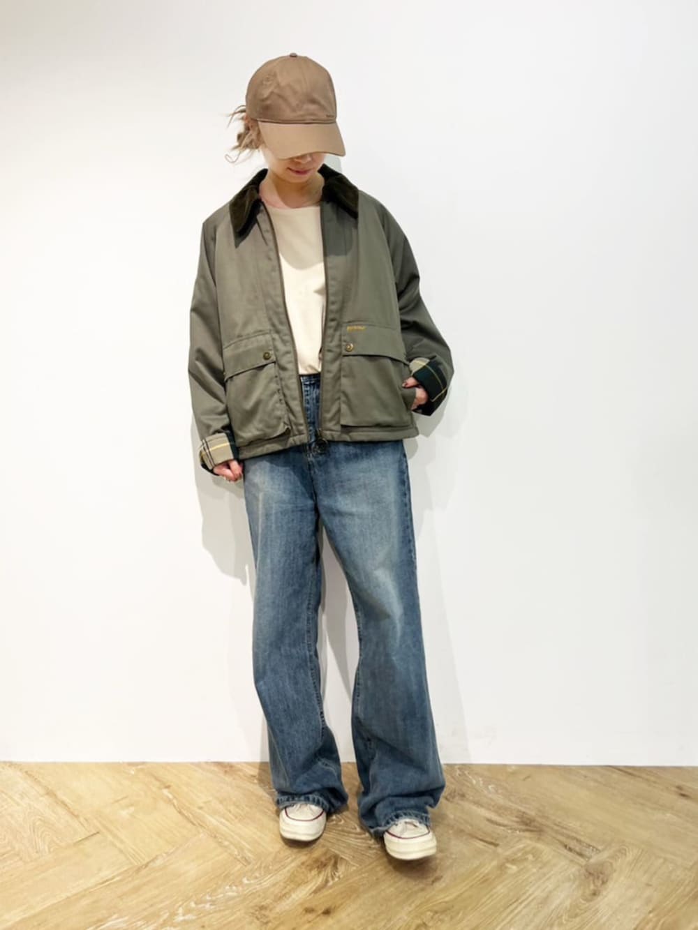 ブラック系のブルゾン、ホワイト系のTシャツ/カットソー、ベージュ系のキャップを着用したレディースの秋コーディネートの2枚目の写真