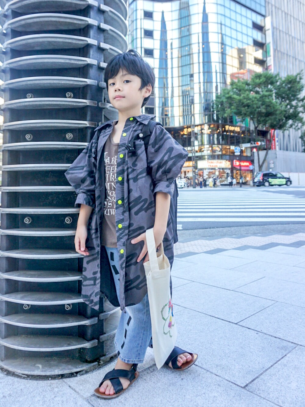 グレー系のシャツ/ブラウス、ブラウン系のタンクトップ、ブルー系のデニムパンツを着用したキッズの夏コーディネートの3枚目の写真
