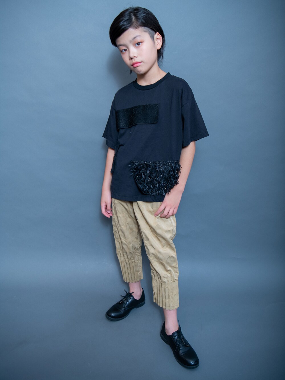 ブラック系のTシャツ/カットソー、ゴールド系のパンツ、ブラック系のシューズを着用したキッズの夏コーディネートの3枚目の写真