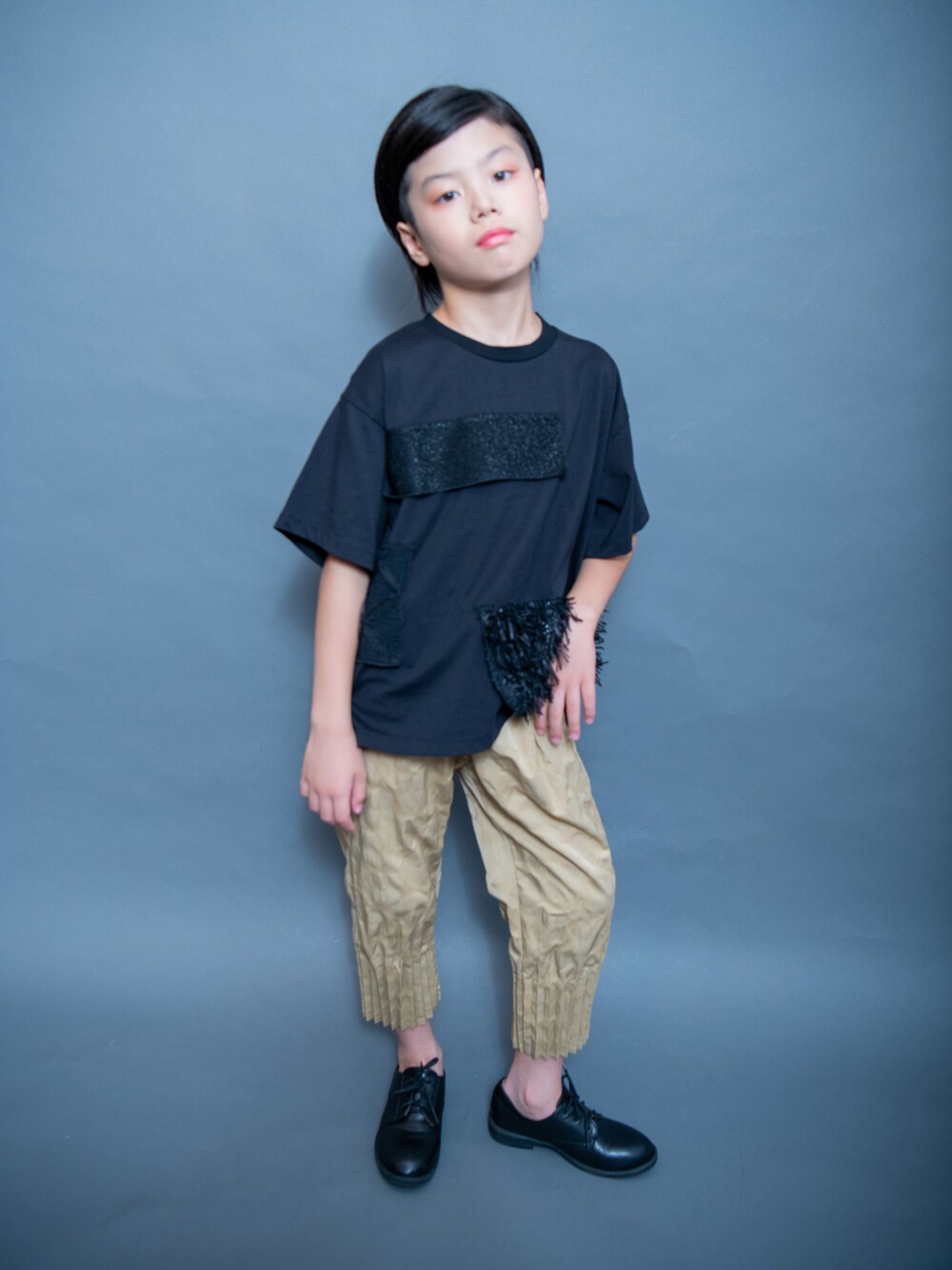 ブラック系のTシャツ/カットソー、ゴールド系のパンツ、ブラック系のシューズを着用したキッズの夏コーディネートの5枚目の写真