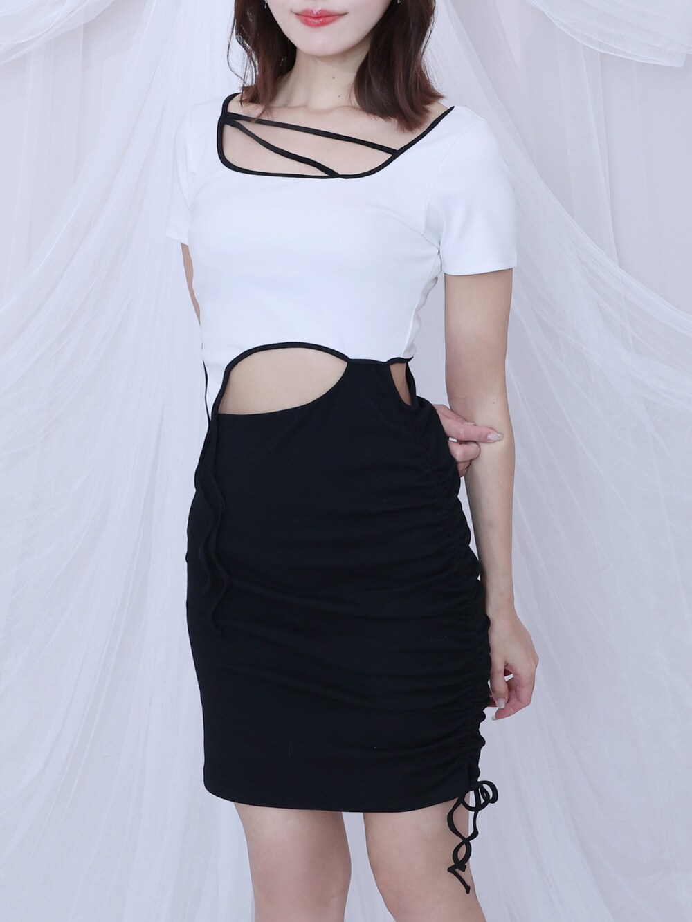 ホワイト系のワンピース、ブラック系のサンダルを着用したレディースの春コーディネートの3枚目の写真