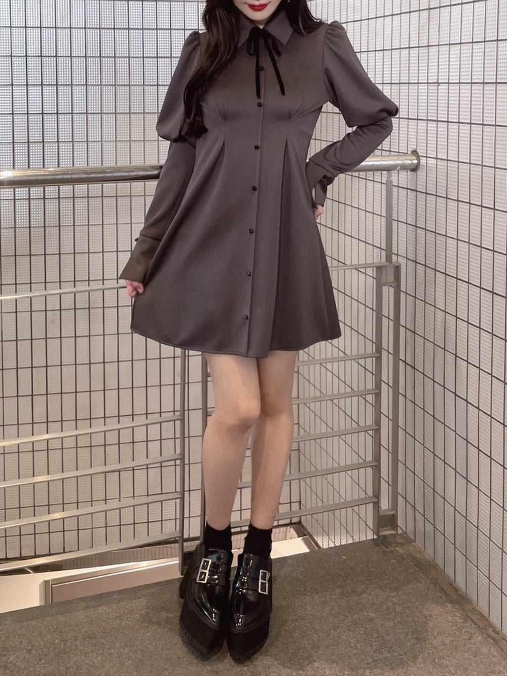 グレー系のワンピース、ブラック系のローファーを着用したレディースの冬コーディネートの2枚目の写真