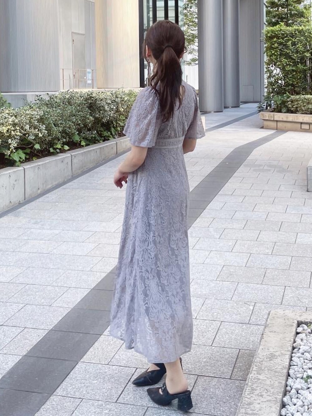 ブラック系のワンピース、ブラック系のパンプスを着用したレディースの夏コーディネートの4枚目の写真