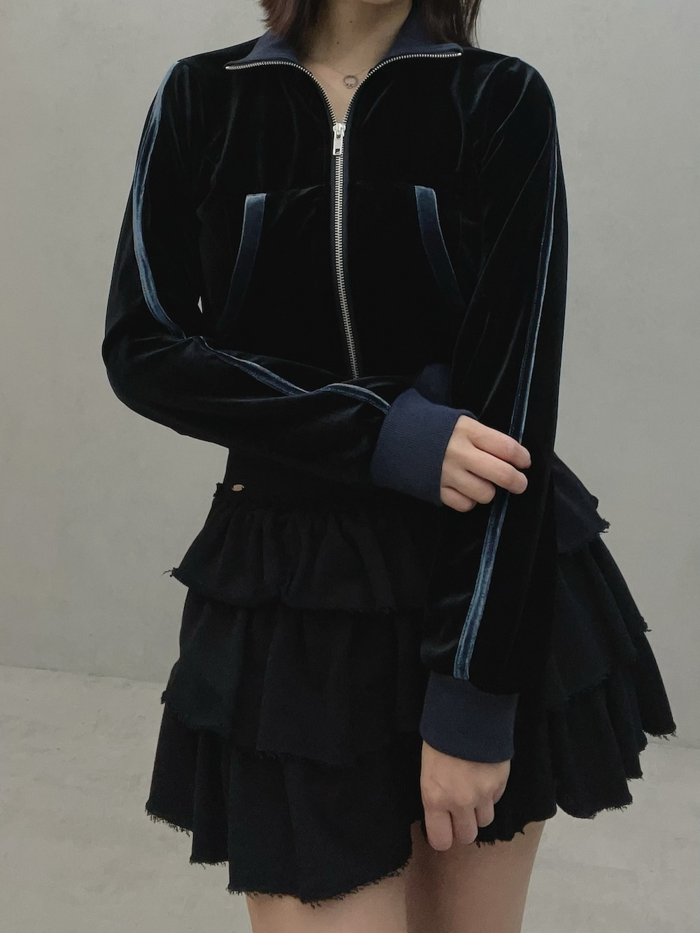 ブラック系のブルゾン、ブラック系のスカート、ホワイト系のスニーカーを着用したレディースの秋コーディネートの6枚目の写真