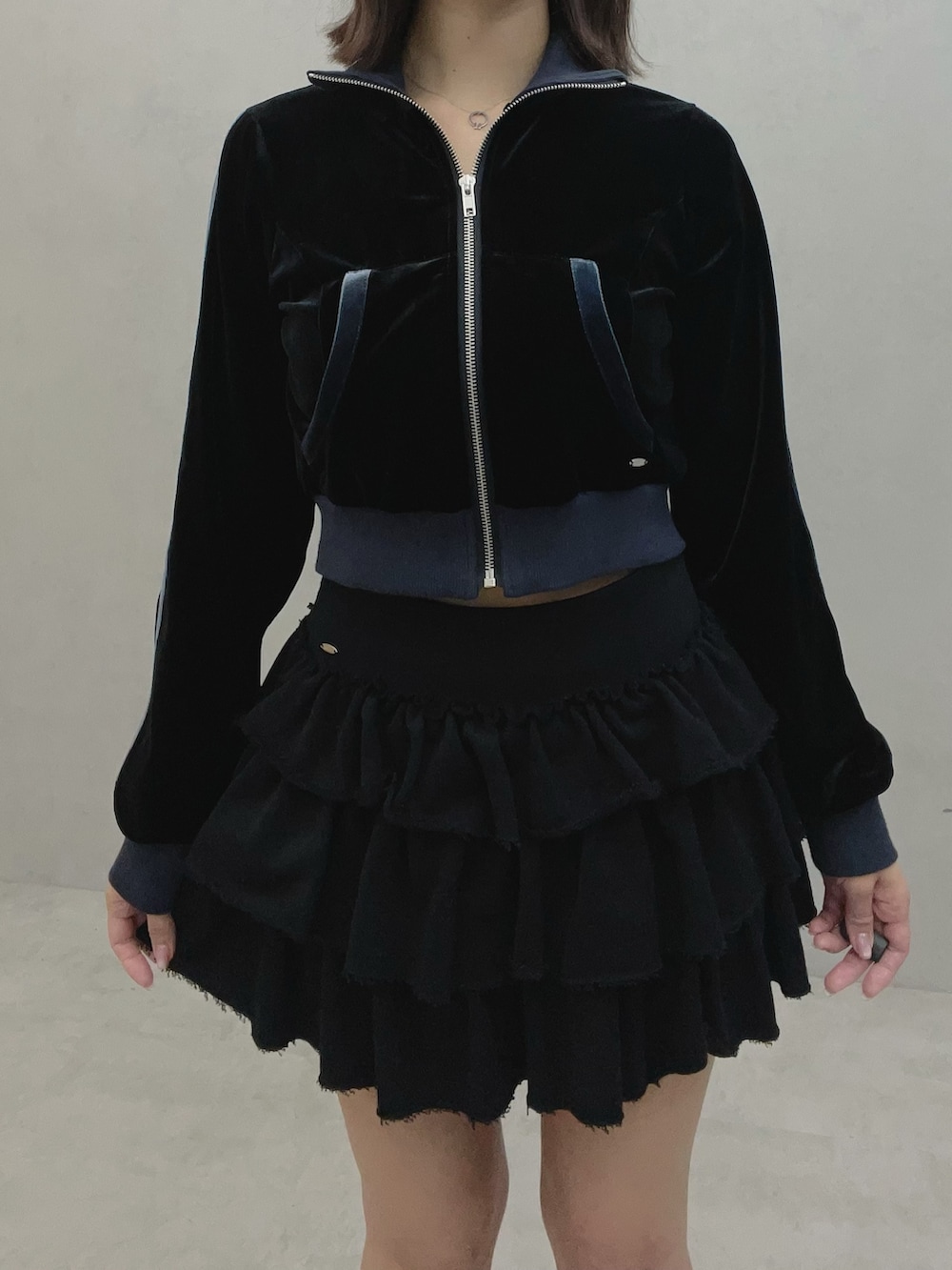 ブラック系のブルゾン、ブラック系のスカート、ホワイト系のスニーカーを着用したレディースの秋コーディネートの9枚目の写真