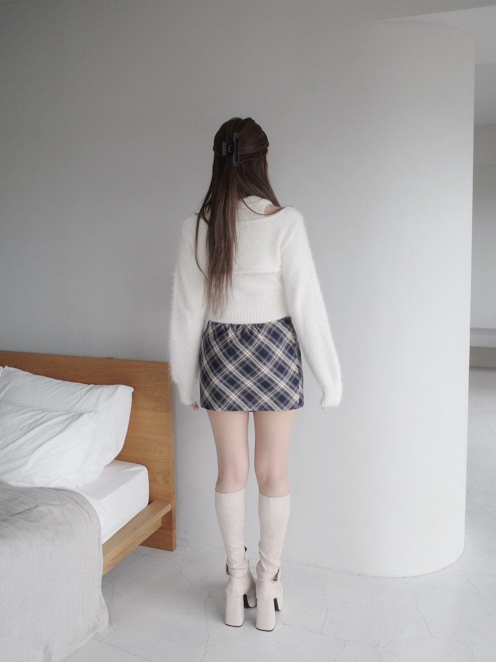 ホワイト系のニット/セーター、ブルー系のスカート、ホワイト系のブーツを着用したレディースの秋コーディネートの3枚目の写真