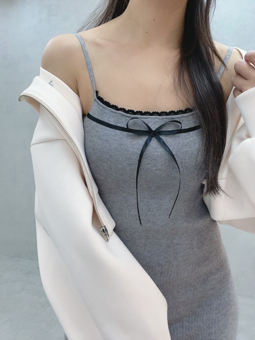 グレー系のワンピース、ホワイト系のパーカー、ホワイト系のブーツを着用したレディースの冬コーディネートの5枚目の写真