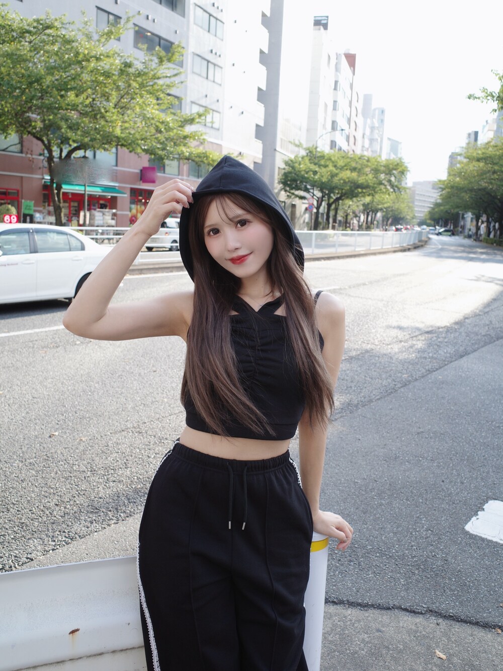 ブラック系のキャミソール、ブラック系のスウェットパンツ、ホワイト系のスニーカーを着用したレディースの夏コーディネートの7枚目の写真