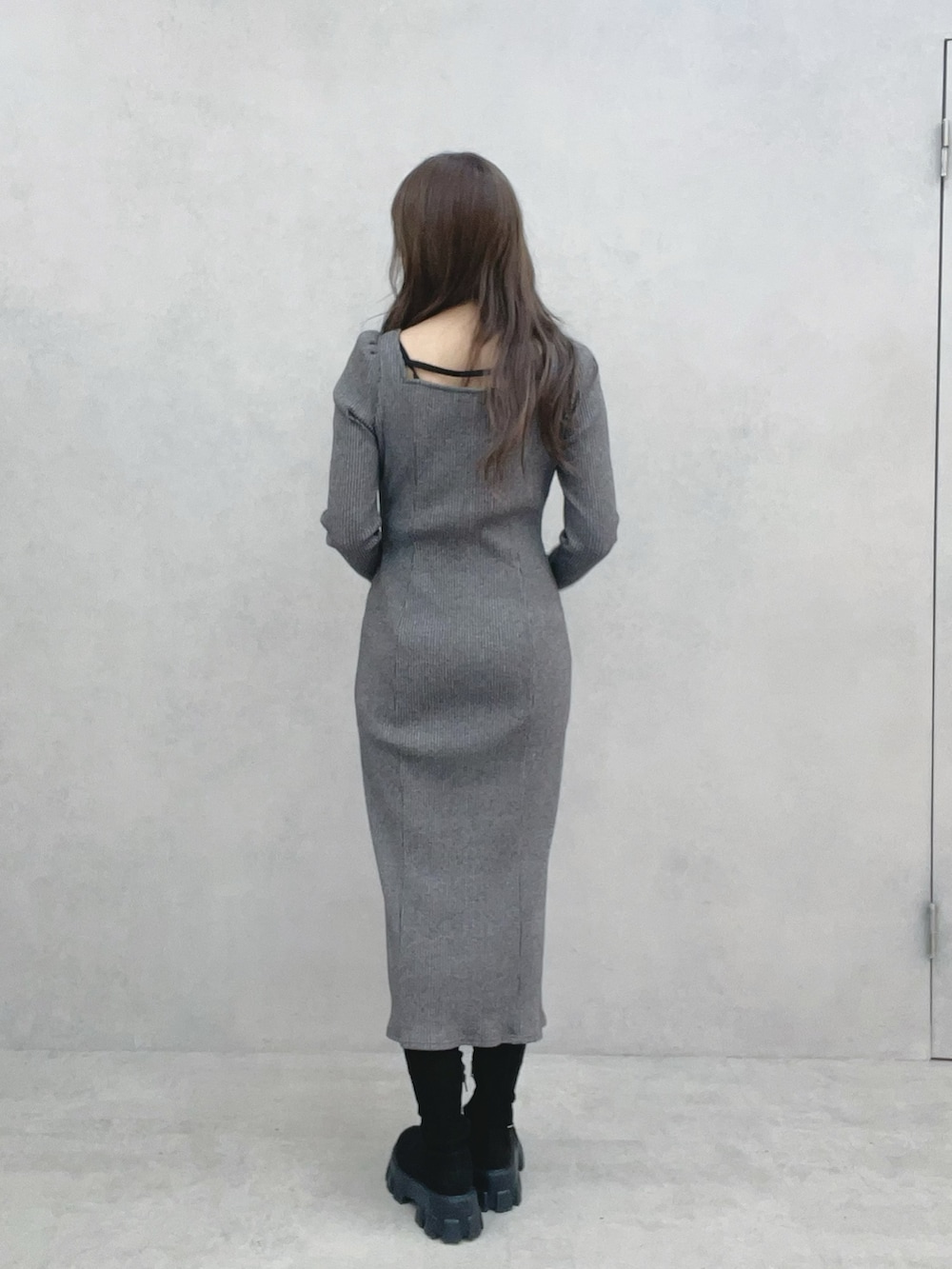 グレー系のワンピース、ブラック系のブーツを着用したレディースの冬コーディネートの5枚目の写真