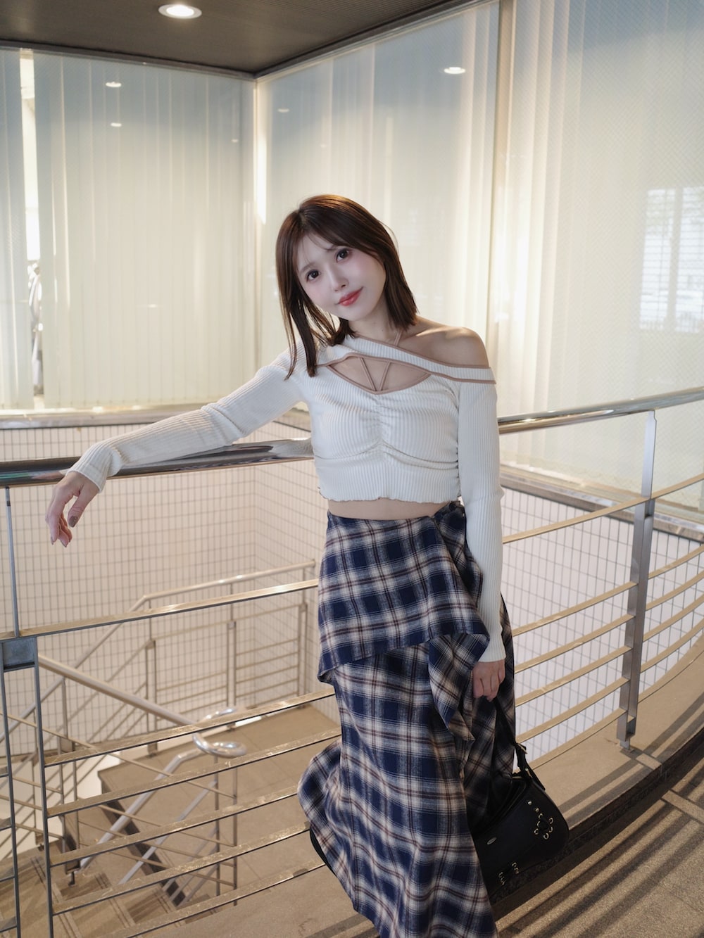 ホワイト系のTシャツ/カットソー、ブルー系のスカート、ブラック系のショルダーバッグを着用したレディースの秋コーディネートの6枚目の写真