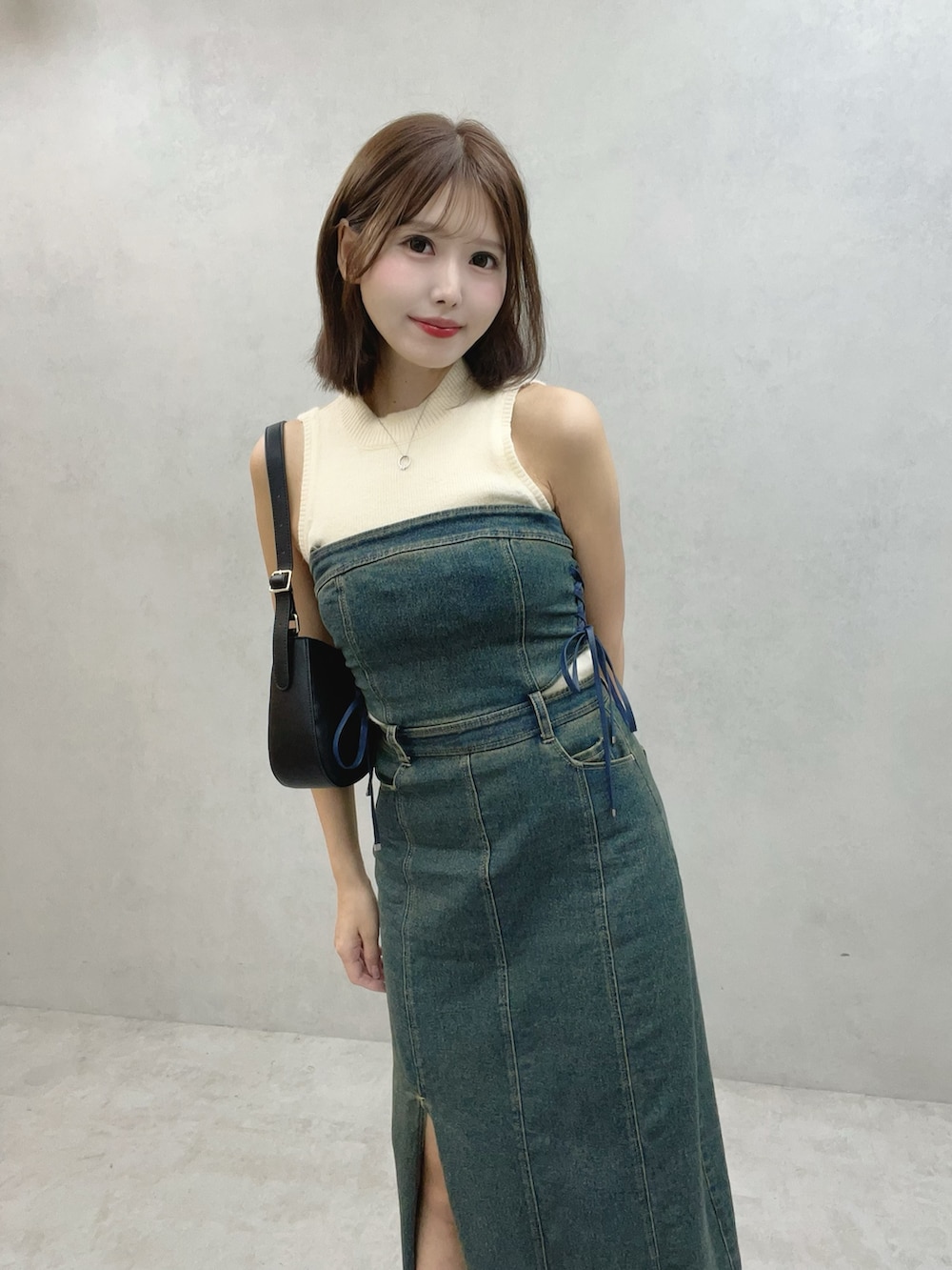 ブルー系のワンピース、ブラック系のサンダル、ホワイト系のニット/セーターを着用したレディースの秋コーディネートの3枚目の写真