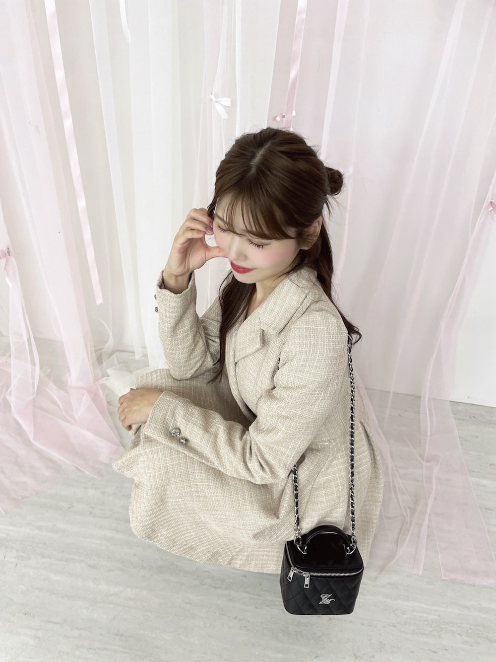 ピンク系のワンピース、ブラック系のハンドバッグ、ホワイト系のブーツを着用したレディースの秋コーディネートの5枚目の写真