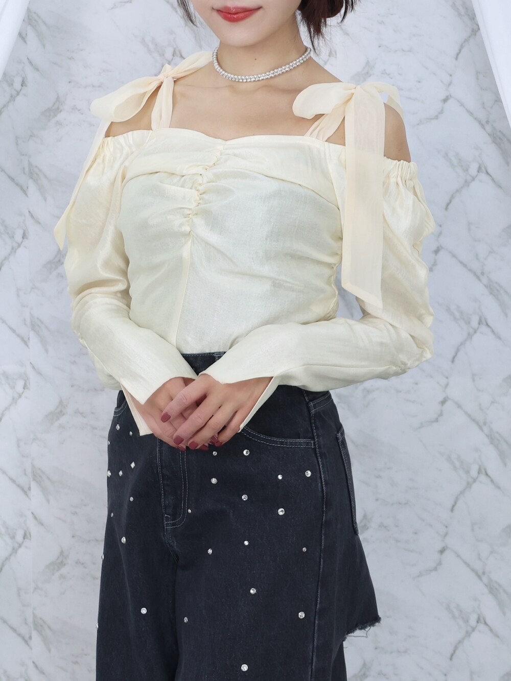 ホワイト系のシャツ/ブラウス、ブラック系のデニムパンツ、ブラック系のハンドバッグを着用したレディースの秋コーディネートの2枚目の写真