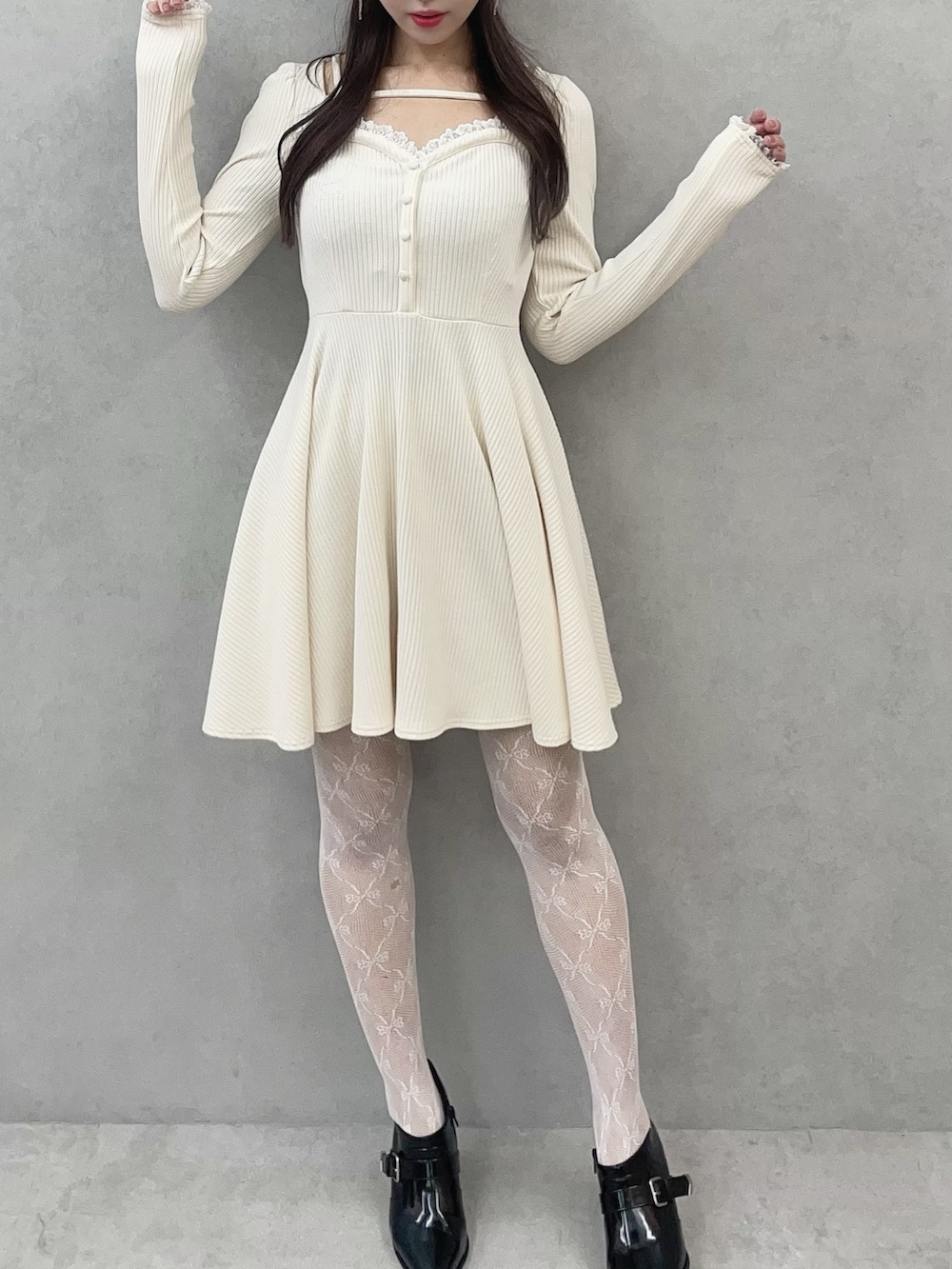 ホワイト系のワンピース、ブラック系のブーツを着用したレディースの冬コーディネートの5枚目の写真