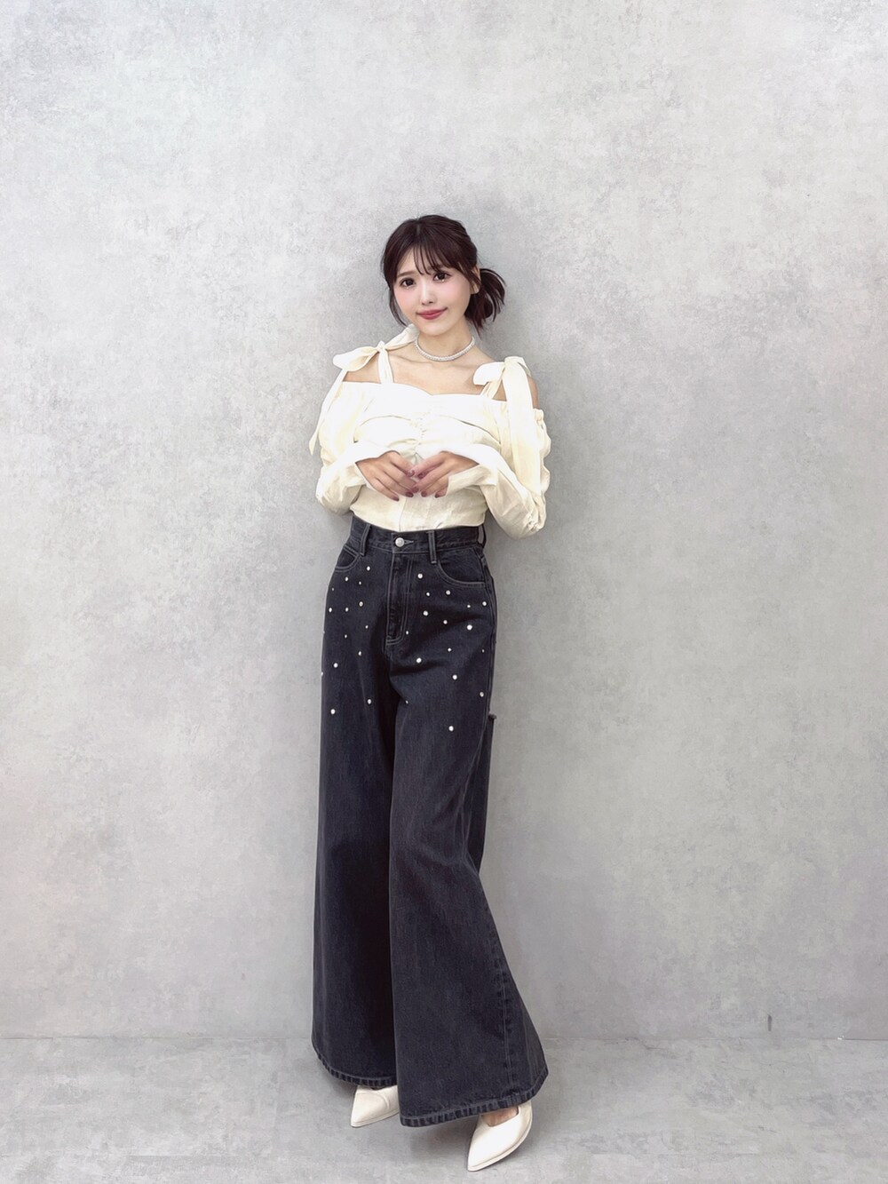 ブラック系のデニムパンツ、ホワイト系のシャツ/ブラウス、ホワイト系のパンプスを着用したレディースの秋コーディネートの4枚目の写真