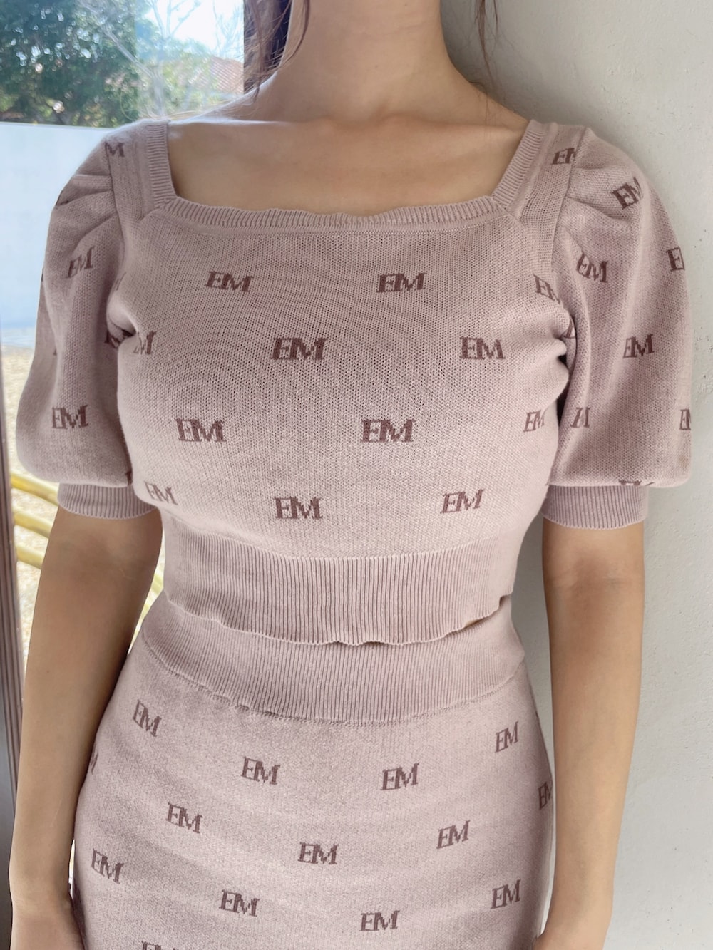 ピンク系のニット/セーター、ピンク系のスカート、ブラック系のパンプスを着用したレディースの冬コーディネートの7枚目の写真