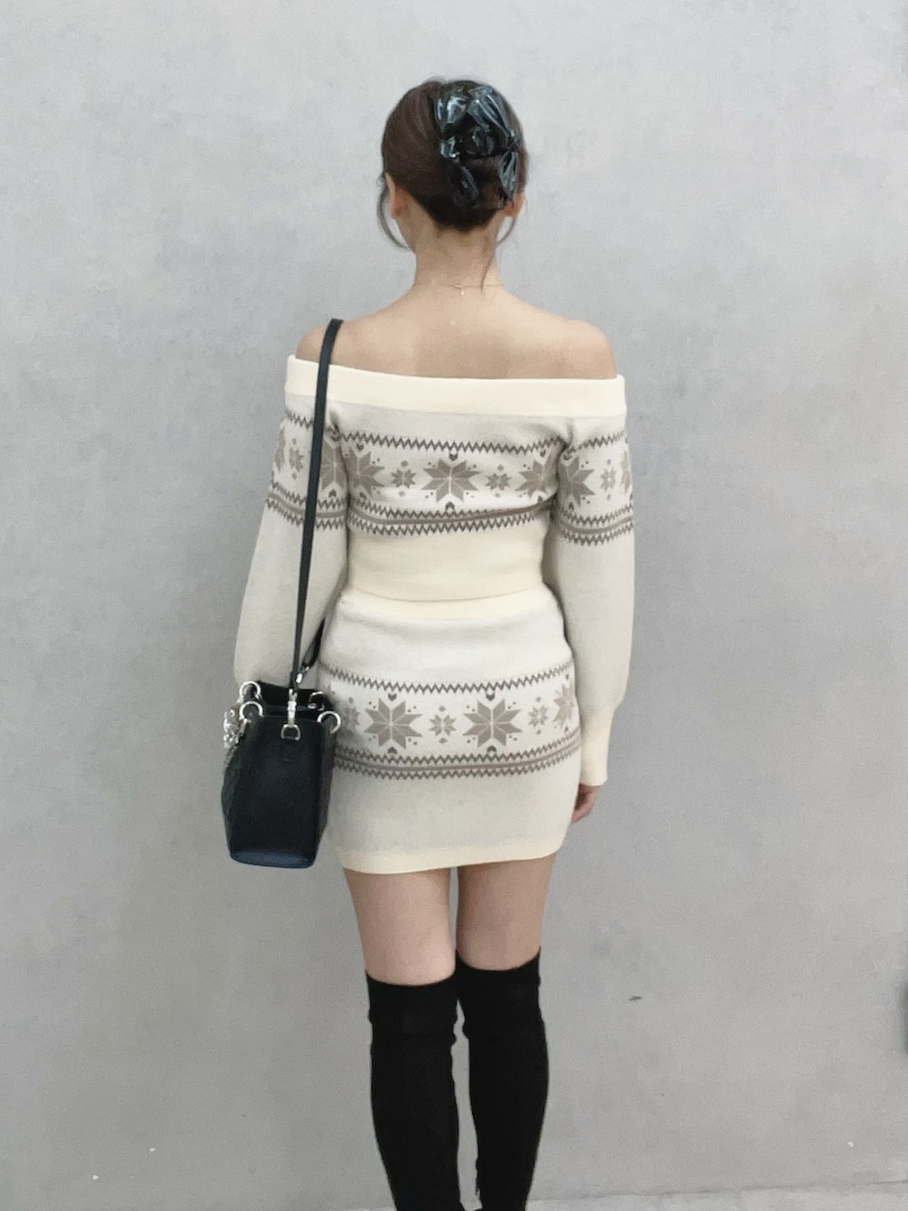 ホワイト系のニット/セーター、ホワイト系のスカート、ブラウン系のブーツを着用したレディースの秋コーディネートの5枚目の写真