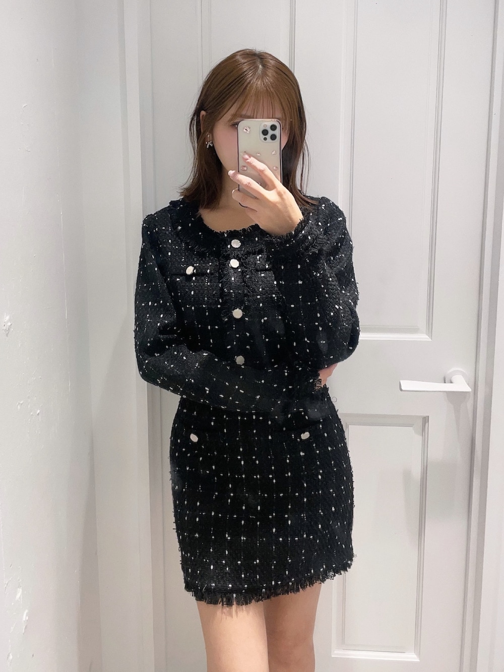 ブラック系のテーラードジャケット、ブラック系のスカートを着用したレディースの冬コーディネートの3枚目の写真