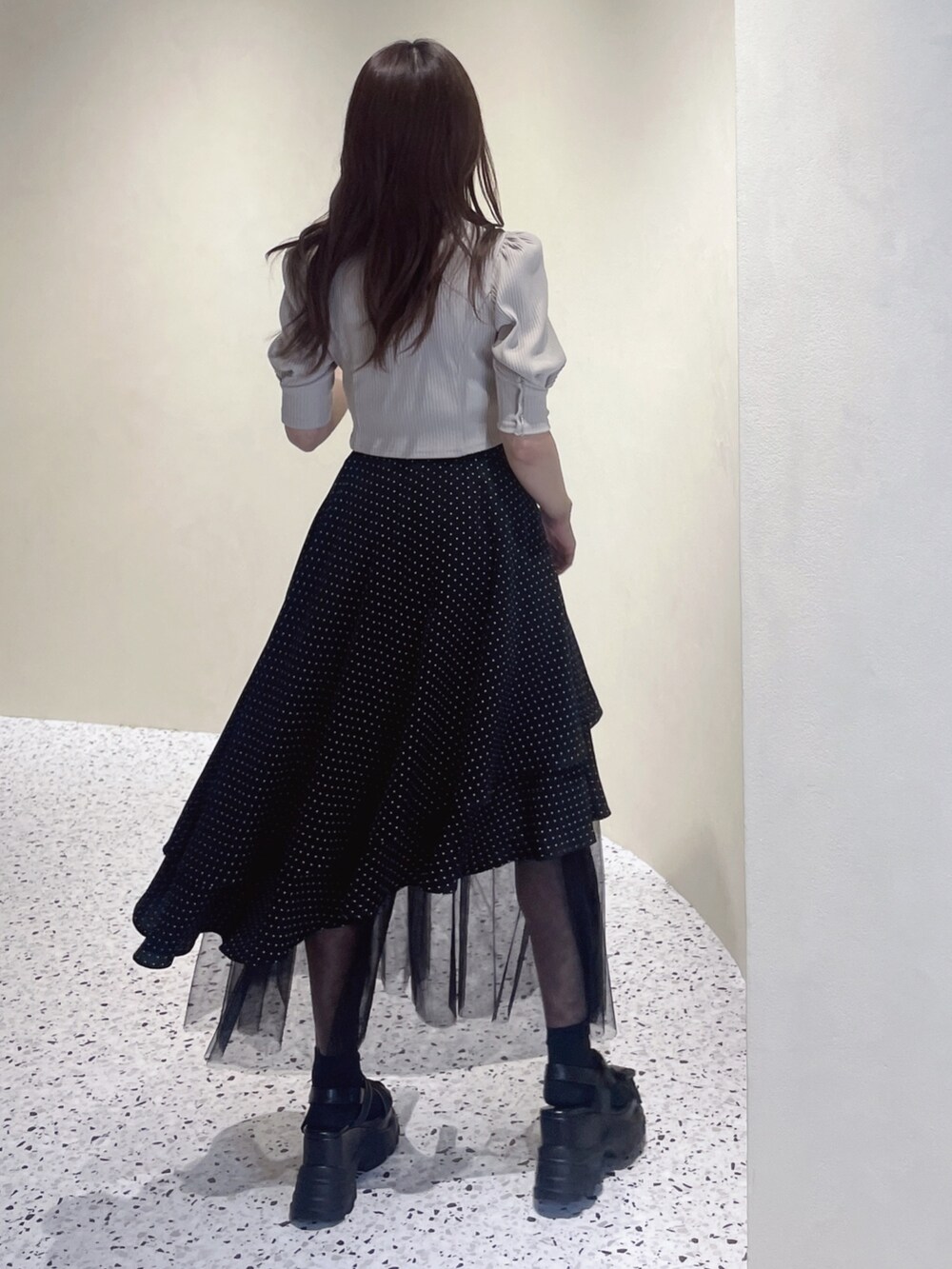 ベージュ系のニット/セーター、その他のスカート、ブラック系のサンダルを着用したレディースの冬コーディネートの4枚目の写真