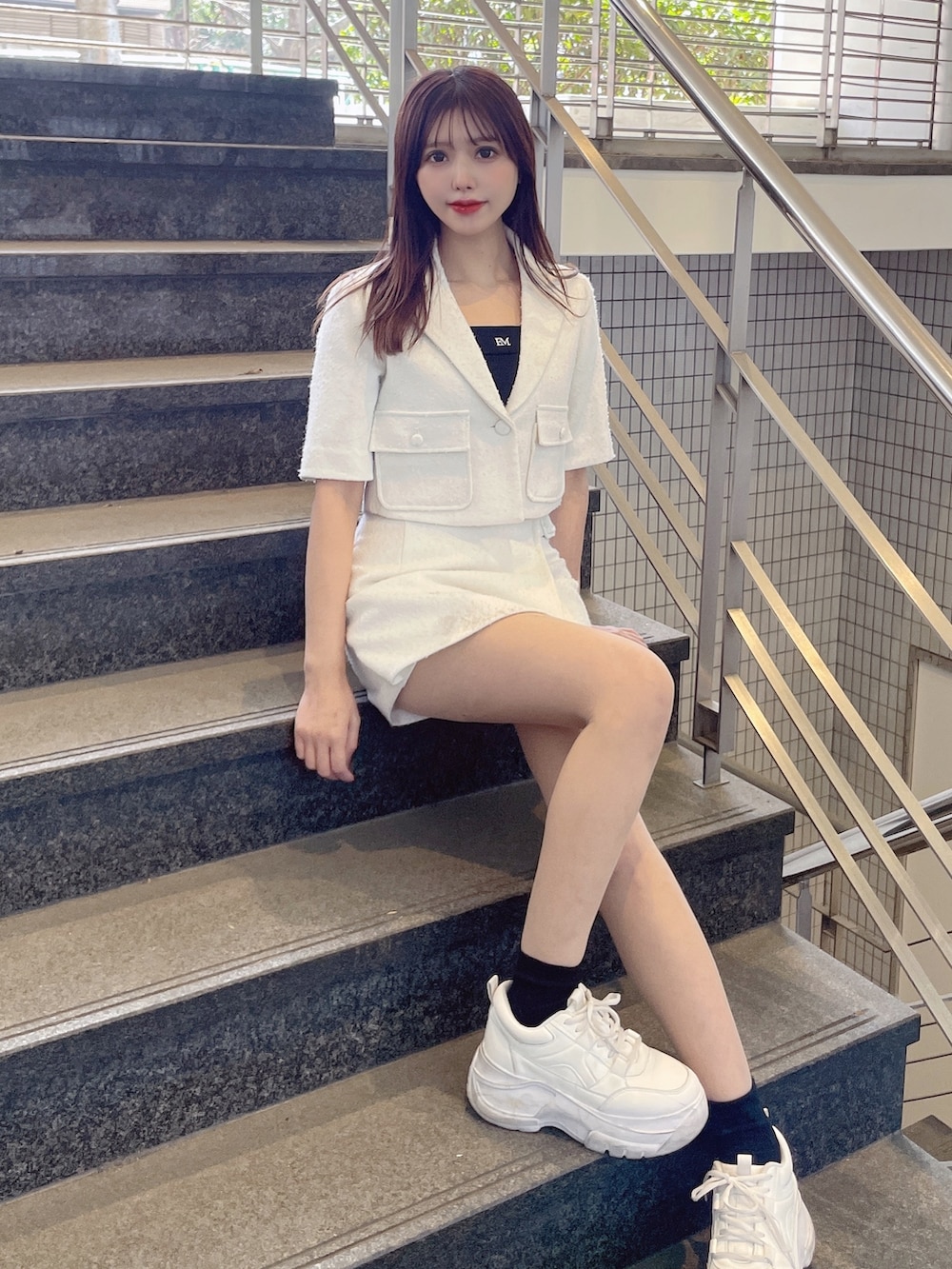 ホワイト系のその他パンツ、ブラック系のキャミソール、ホワイト系のテーラードジャケットを着用したレディースの春コーディネートの4枚目の写真