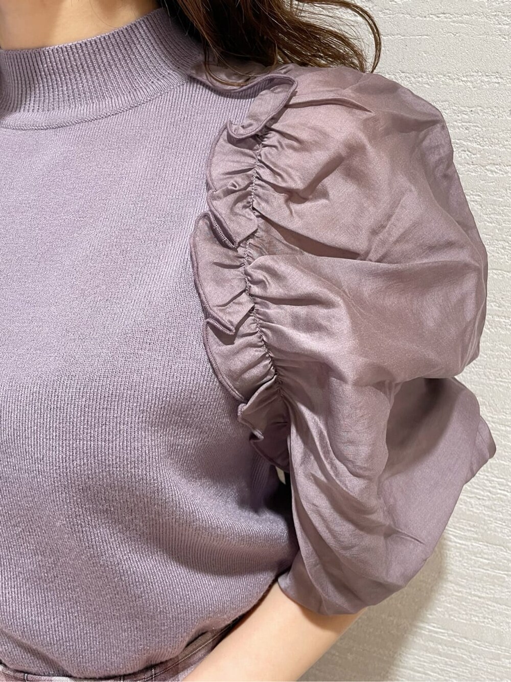 パープル系のスカート、ベージュ系のブーツ、パープル系のニット/セーターを着用したレディースの冬コーディネートの6枚目の写真