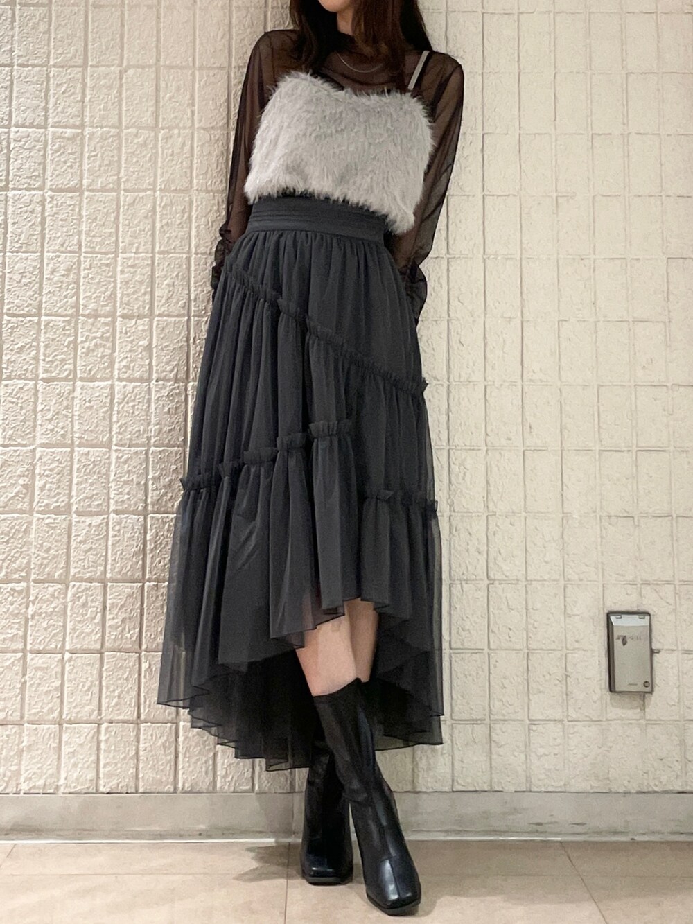 グレー系のスカート、ブラック系のブーツ、グレー系のTシャツ/カットソーを着用したレディースの夏コーディネートの2枚目の写真