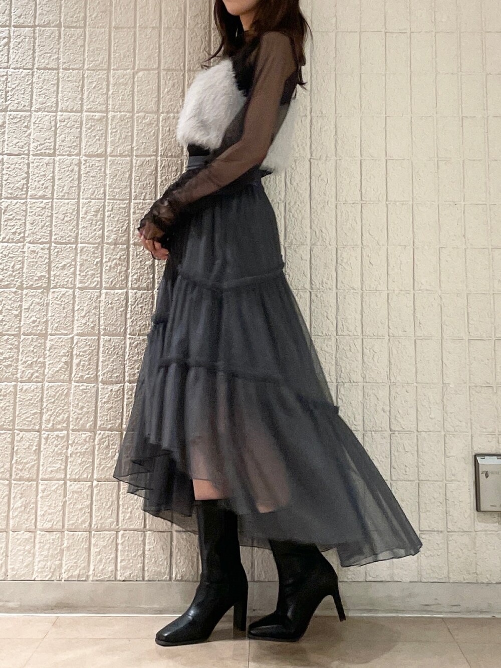 グレー系のスカート、ブラック系のブーツ、グレー系のTシャツ/カットソーを着用したレディースの夏コーディネートの3枚目の写真