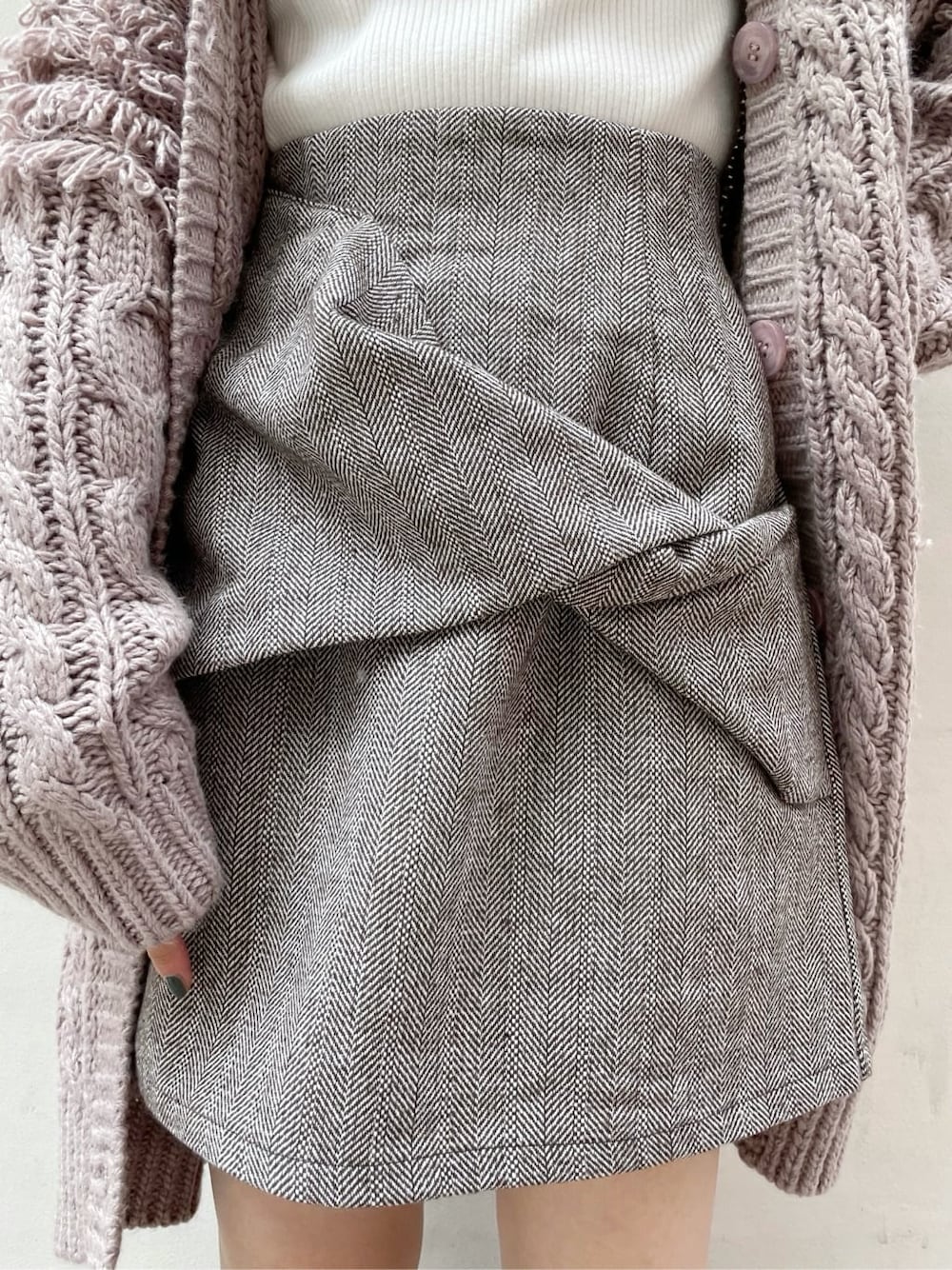 ブラウン系のスカート、ベージュ系のブーツ、ホワイト系のニット/セーターを着用したレディースの秋コーディネートの8枚目の写真