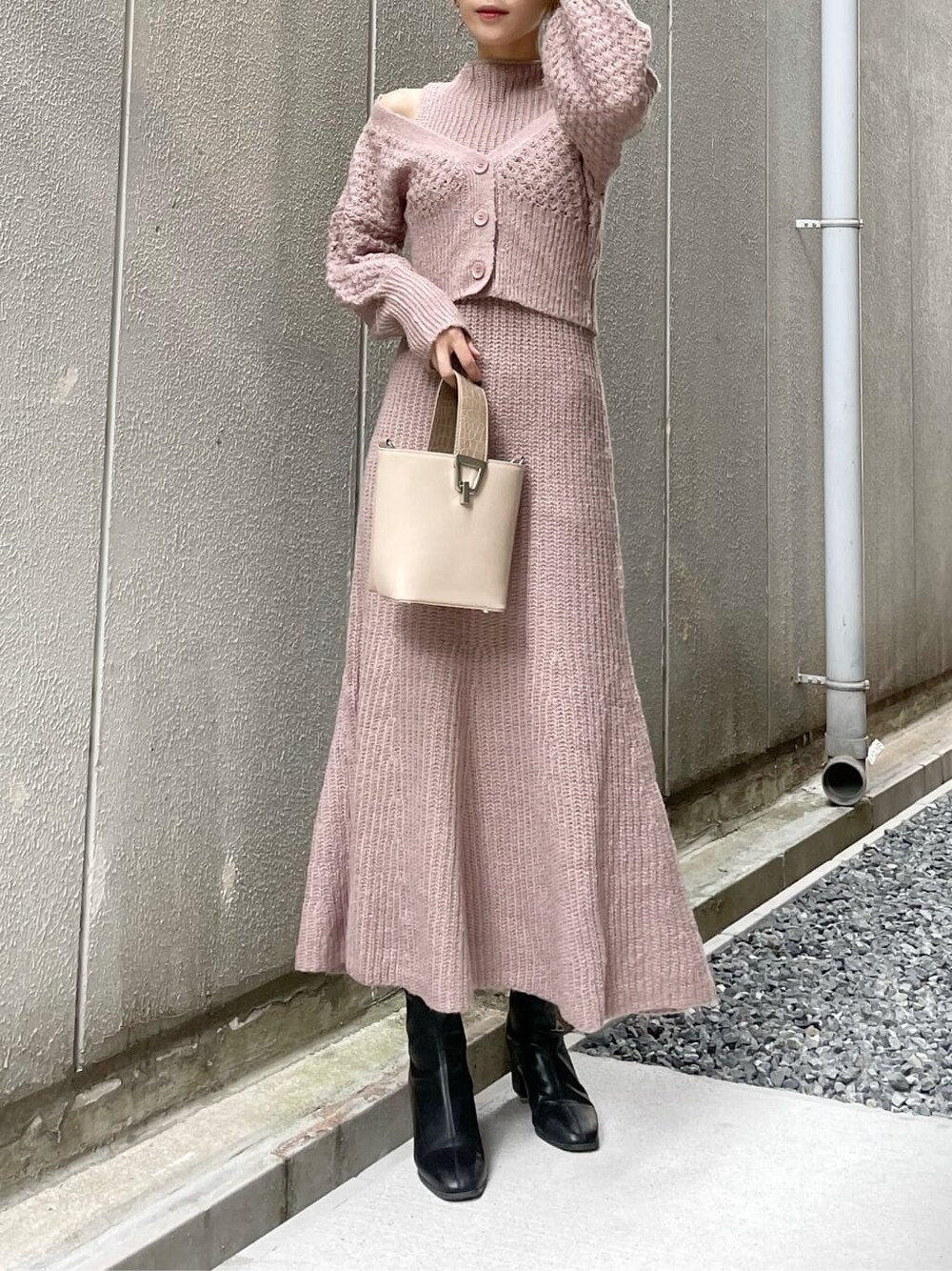 ベージュ系のワンピース、ブラック系のブーツ、ベージュ系のハンドバッグを着用したレディースの秋コーディネートの3枚目の写真