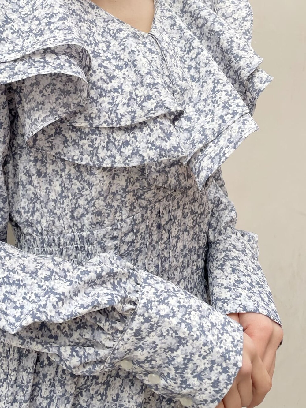 ベージュ系のトレンチコート、ブルー系のワンピース、ブラック系のブーツを着用したレディースの冬コーディネートの9枚目の写真