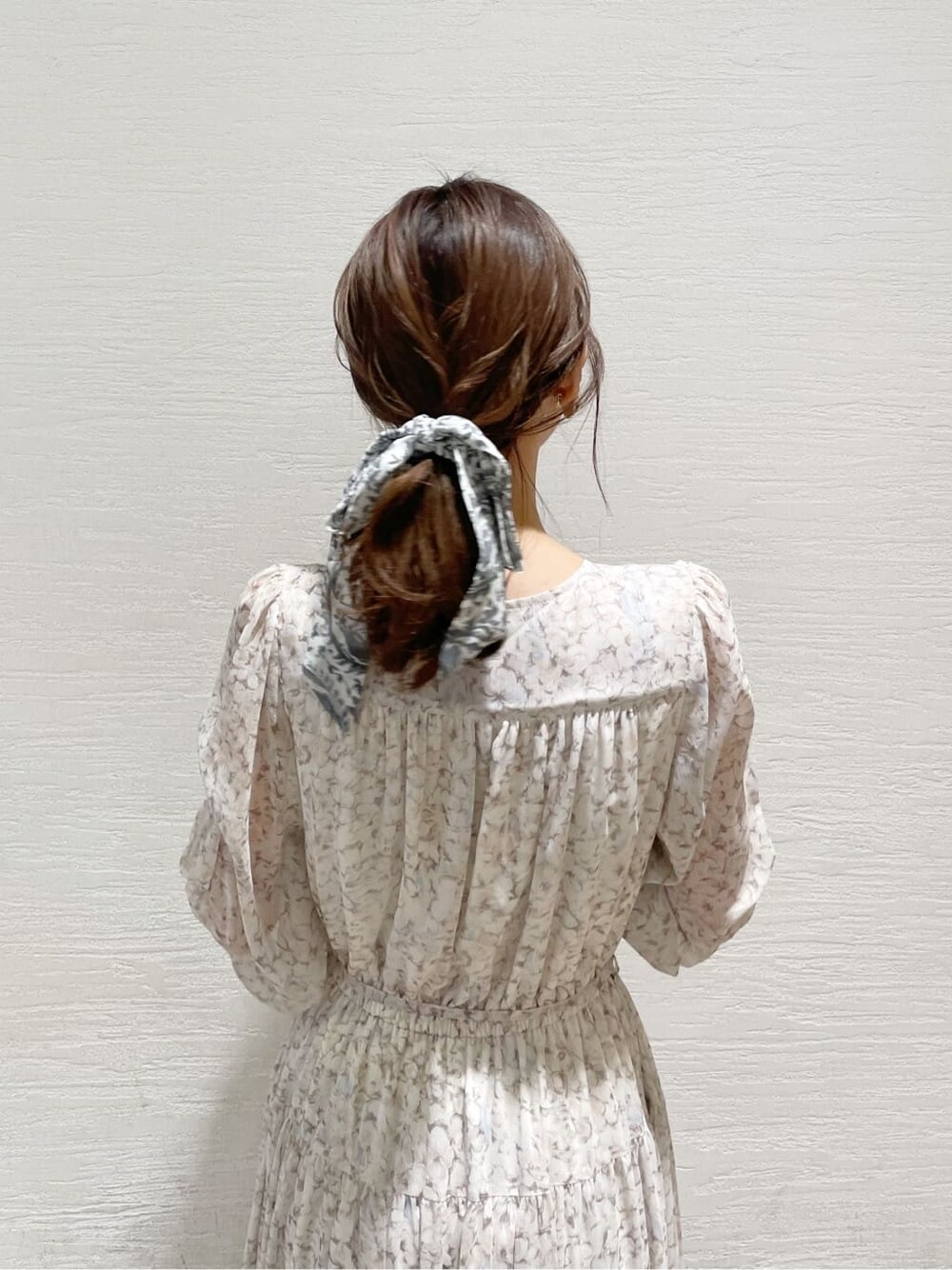 グレー系のトレンチコート、オレンジ系のワンピース、グレー系のニット/セーターを着用したレディースの冬コーディネートの8枚目の写真