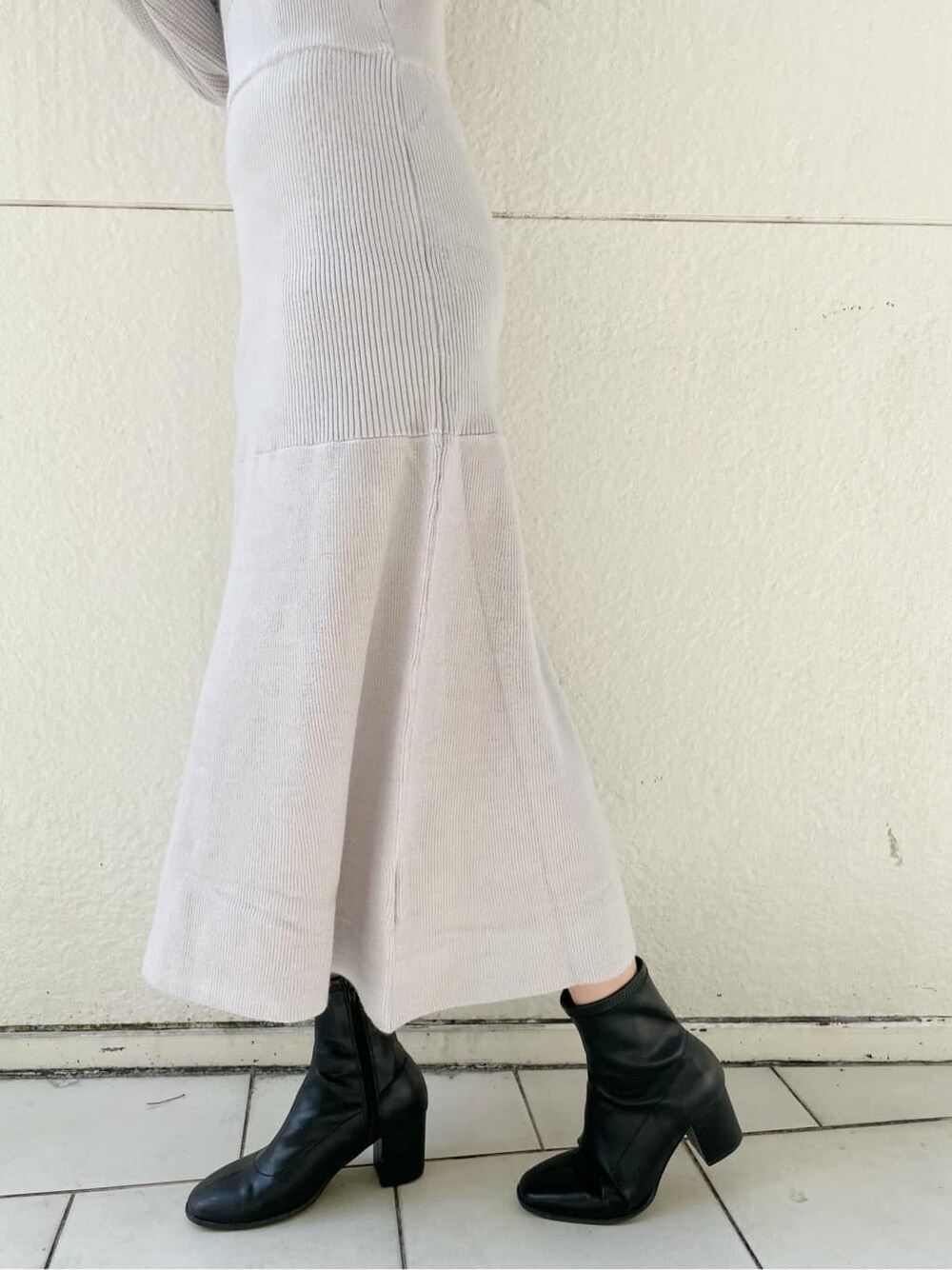 グレー系のブルゾン、ブラック系のブーツ、グレー系のワンピースを着用したレディースの秋コーディネートの10枚目の写真