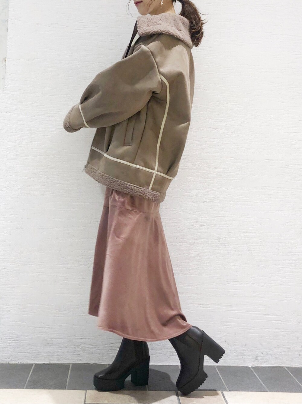 ピンク系のワンピース、ブラウン系のブーツ、ベージュ系のブルゾンを着用したレディースの秋コーディネートの2枚目の写真