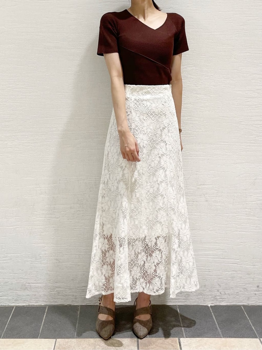 ホワイト系のスカート、ピンク系のダウンジャケット/コート、ブラウン系のニット/セーターを着用したレディースの夏コーディネートの7枚目の写真